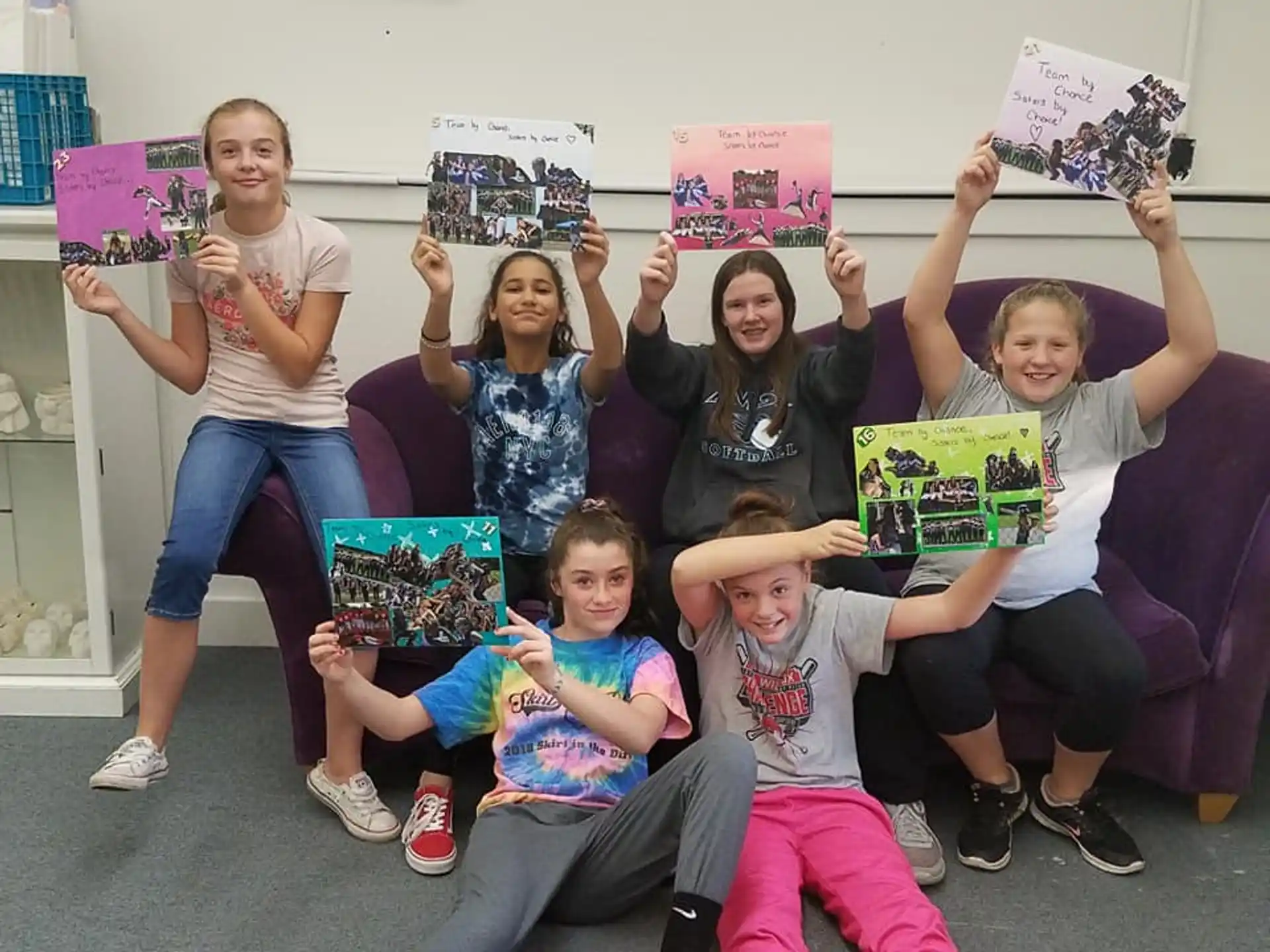 a group of people holding up books