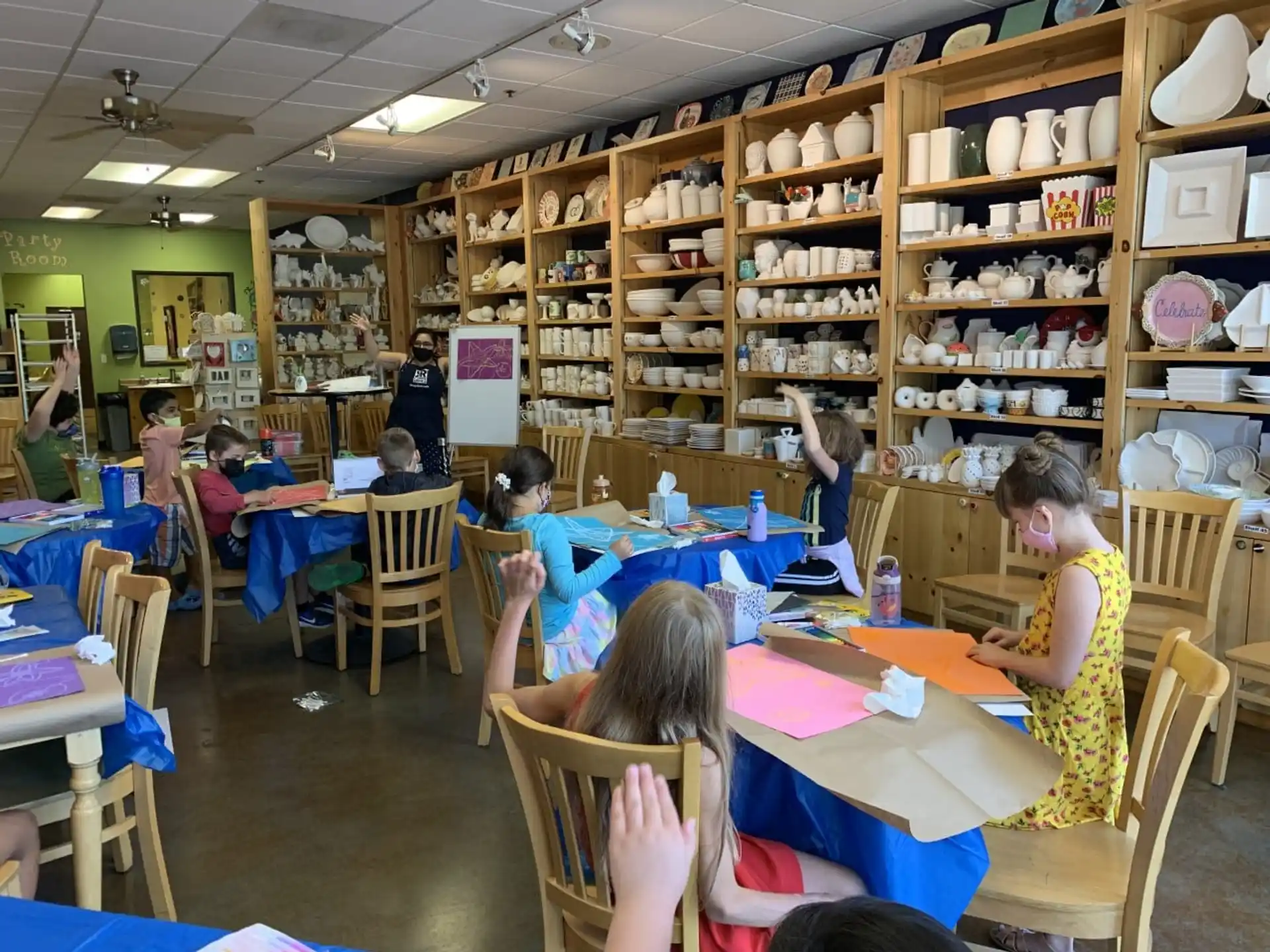 a group of people sitting at tables in a library