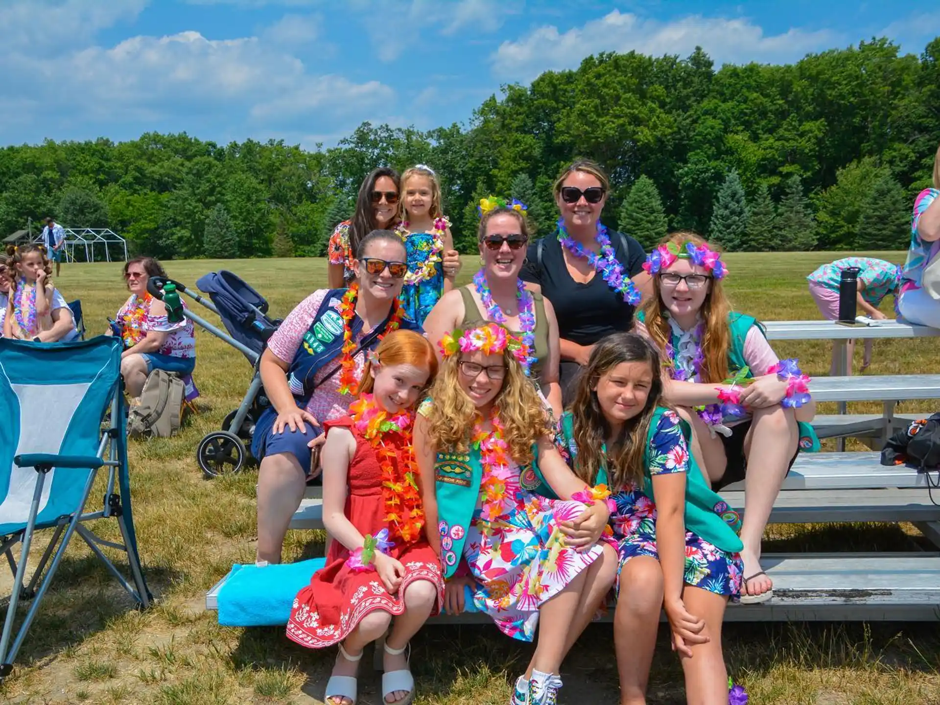 a group of people sitting on a bench posing for the camera
