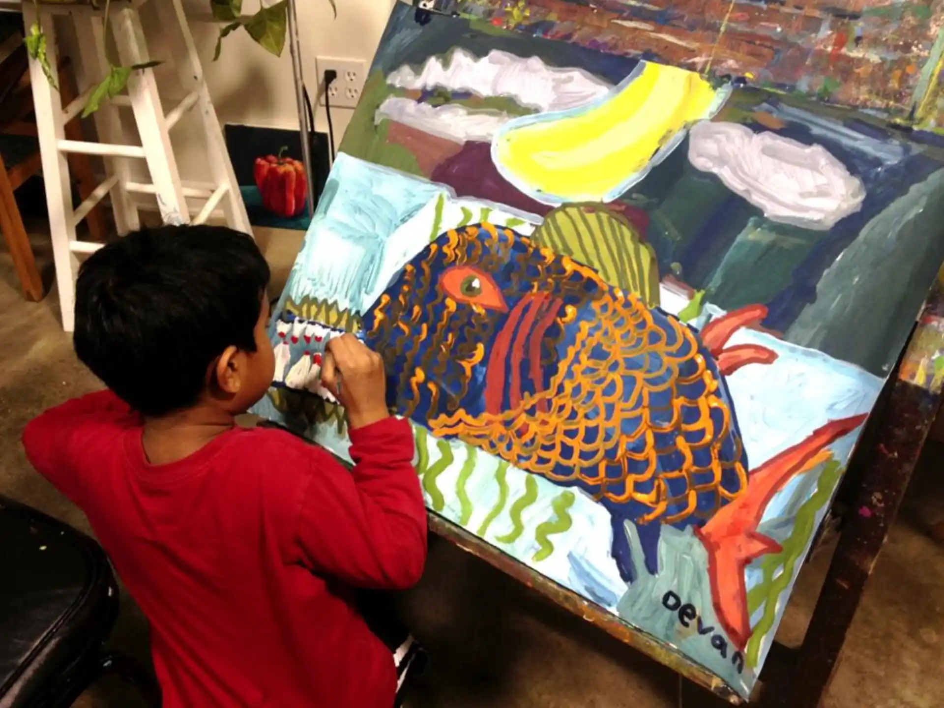 a child painting on a canvas