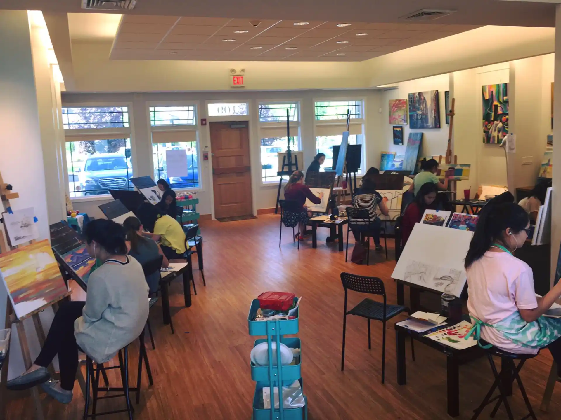 a group of people sitting at desks in a room