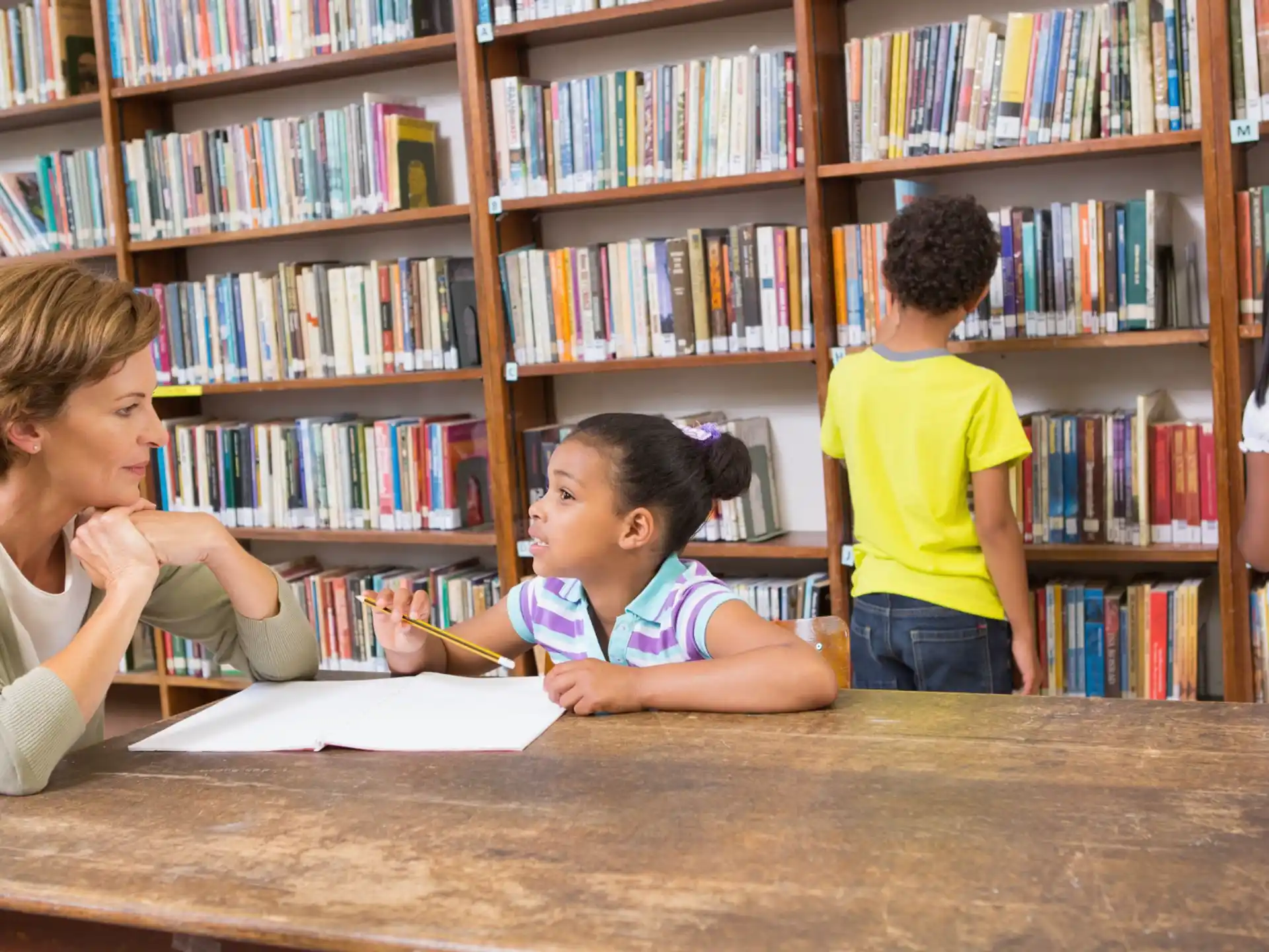 a person and children in a library