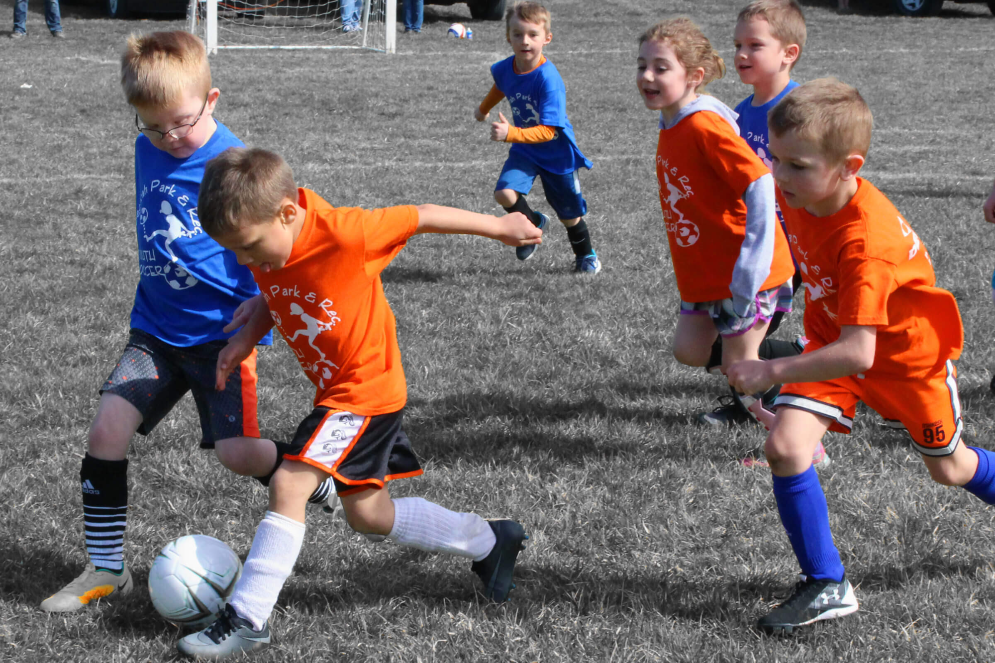 a group of kids playing football