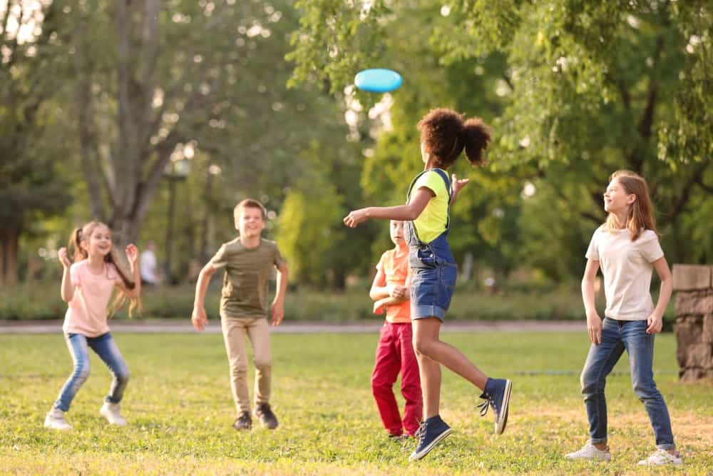 a group of people playing frisbee