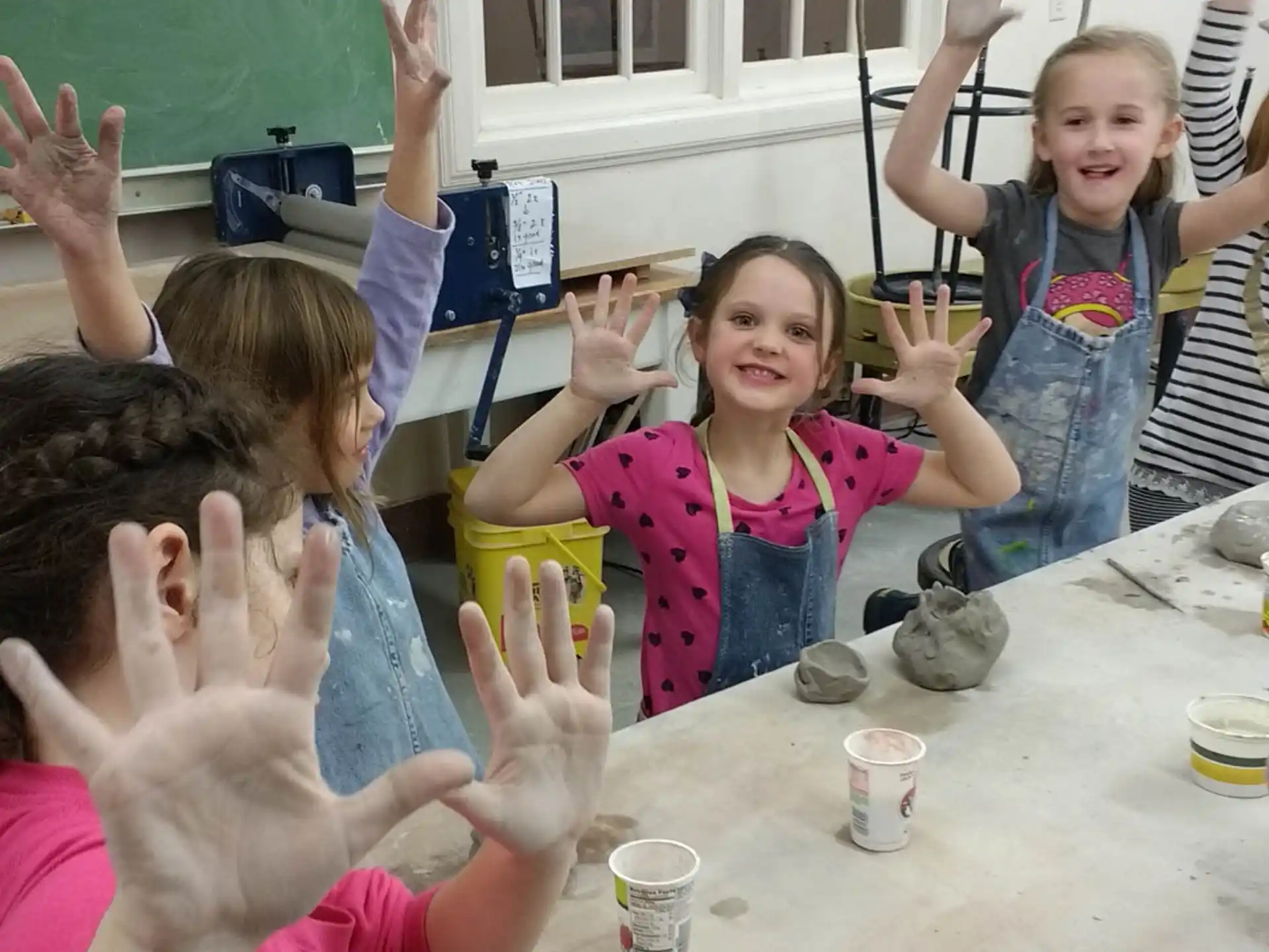 a group of children raising their hands