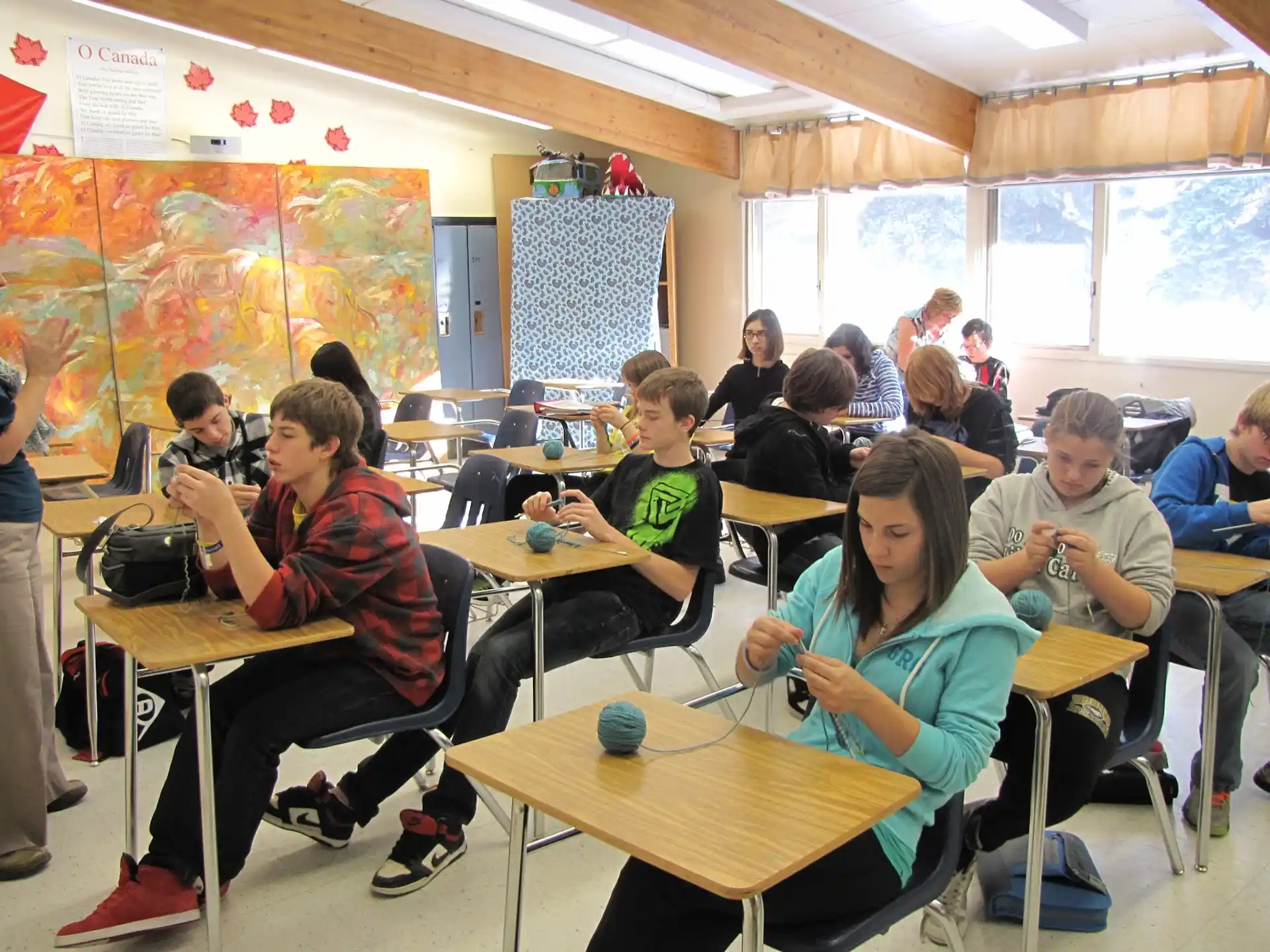 a group of people sitting at desks in a classroom