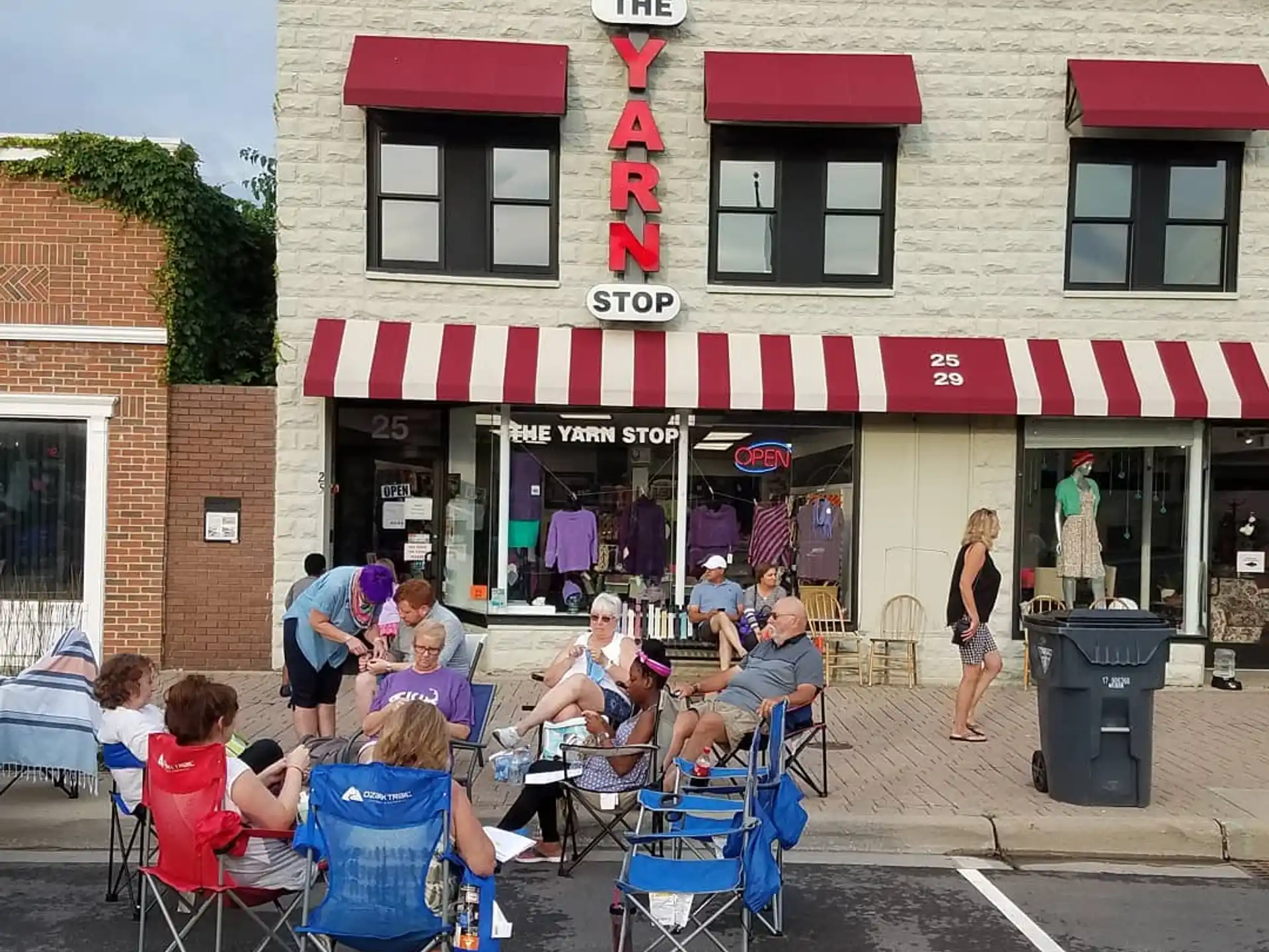 a group of people sitting outside a restaurant