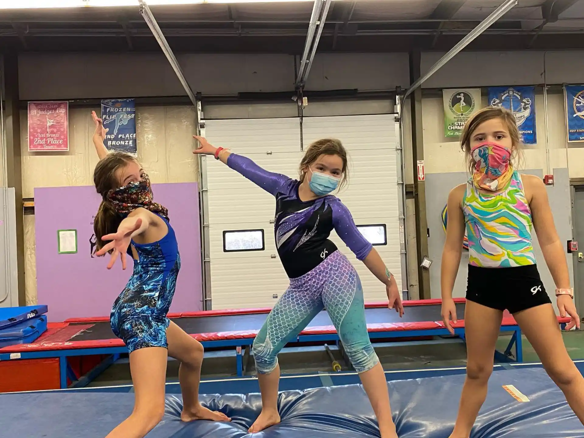 a group of girls dancing on a mat in a gym