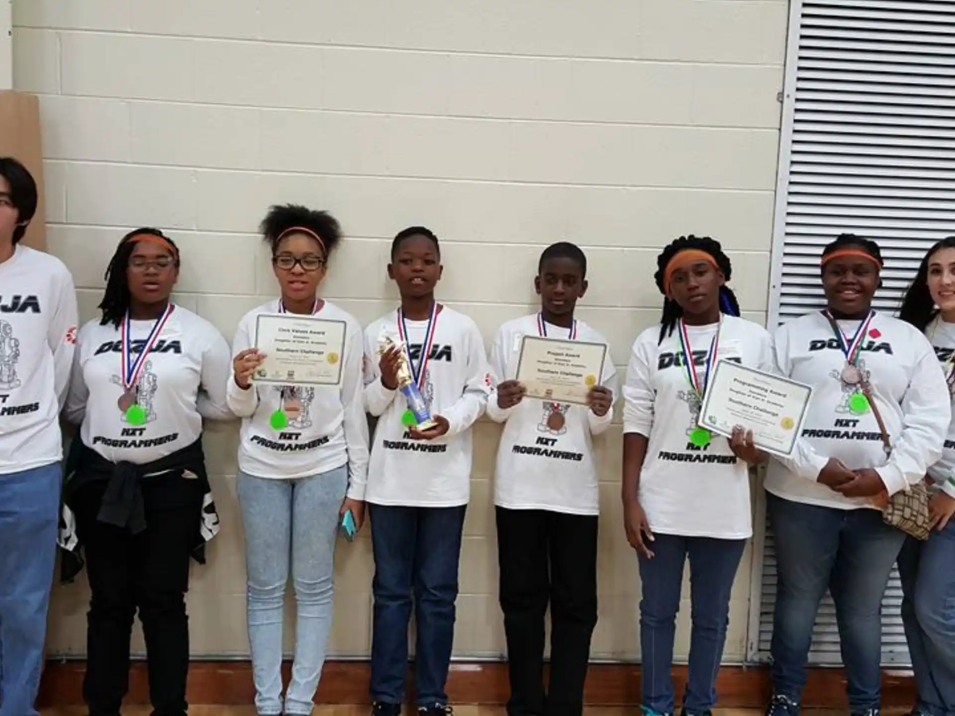 a group of people holding certificates