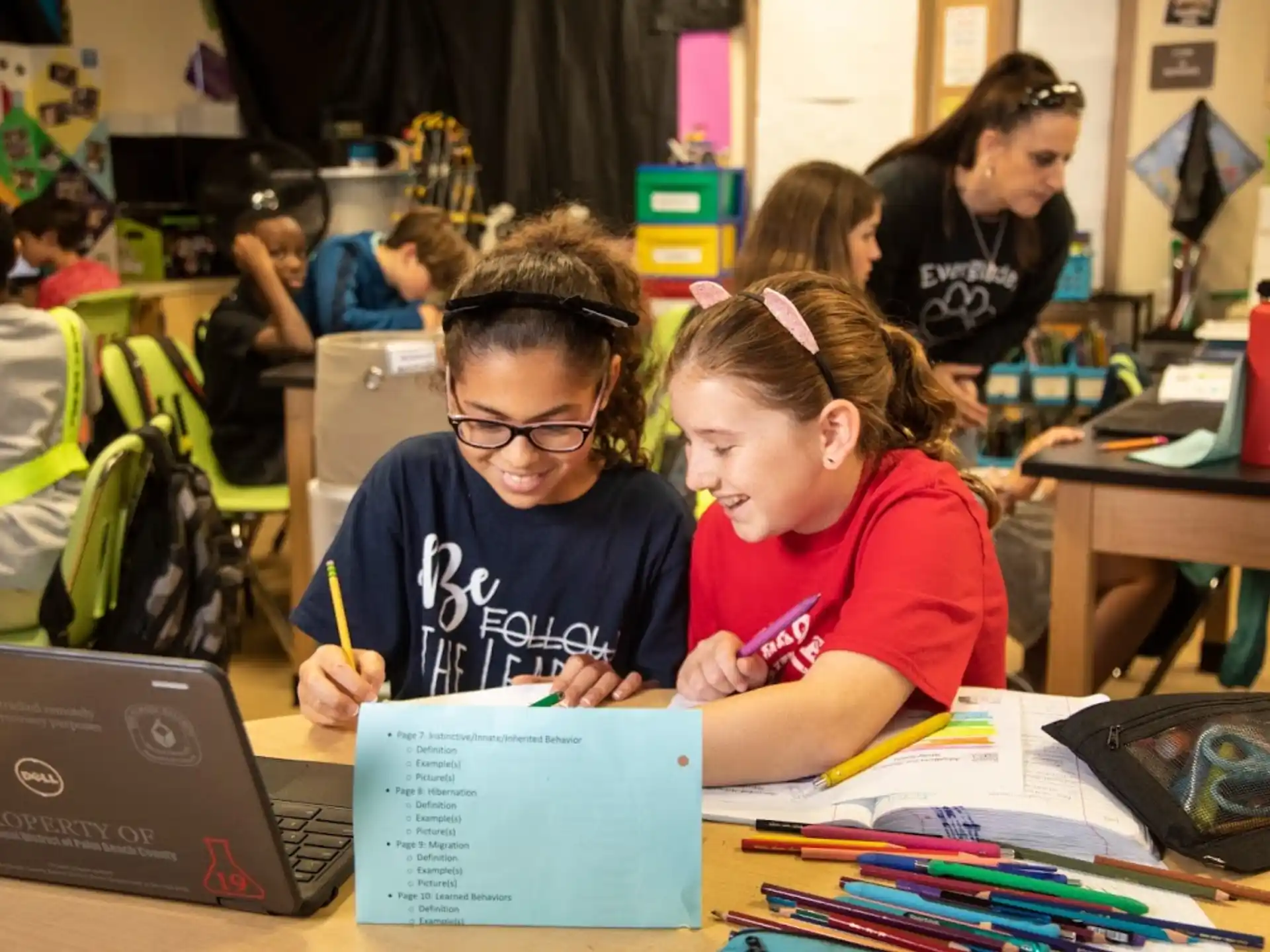 a few young girls working on their laptops