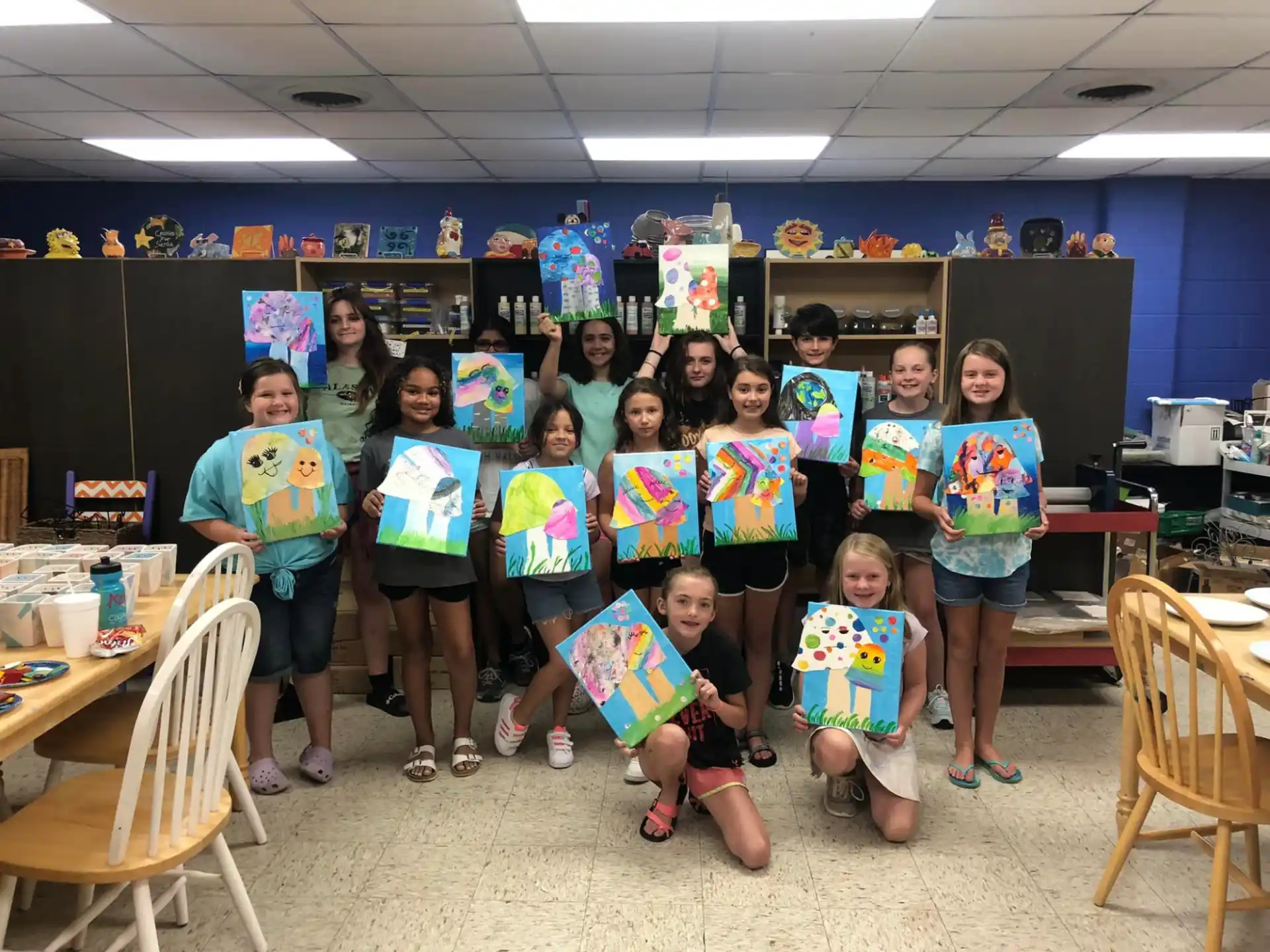 a group of children holding up colorful signs in a classroom