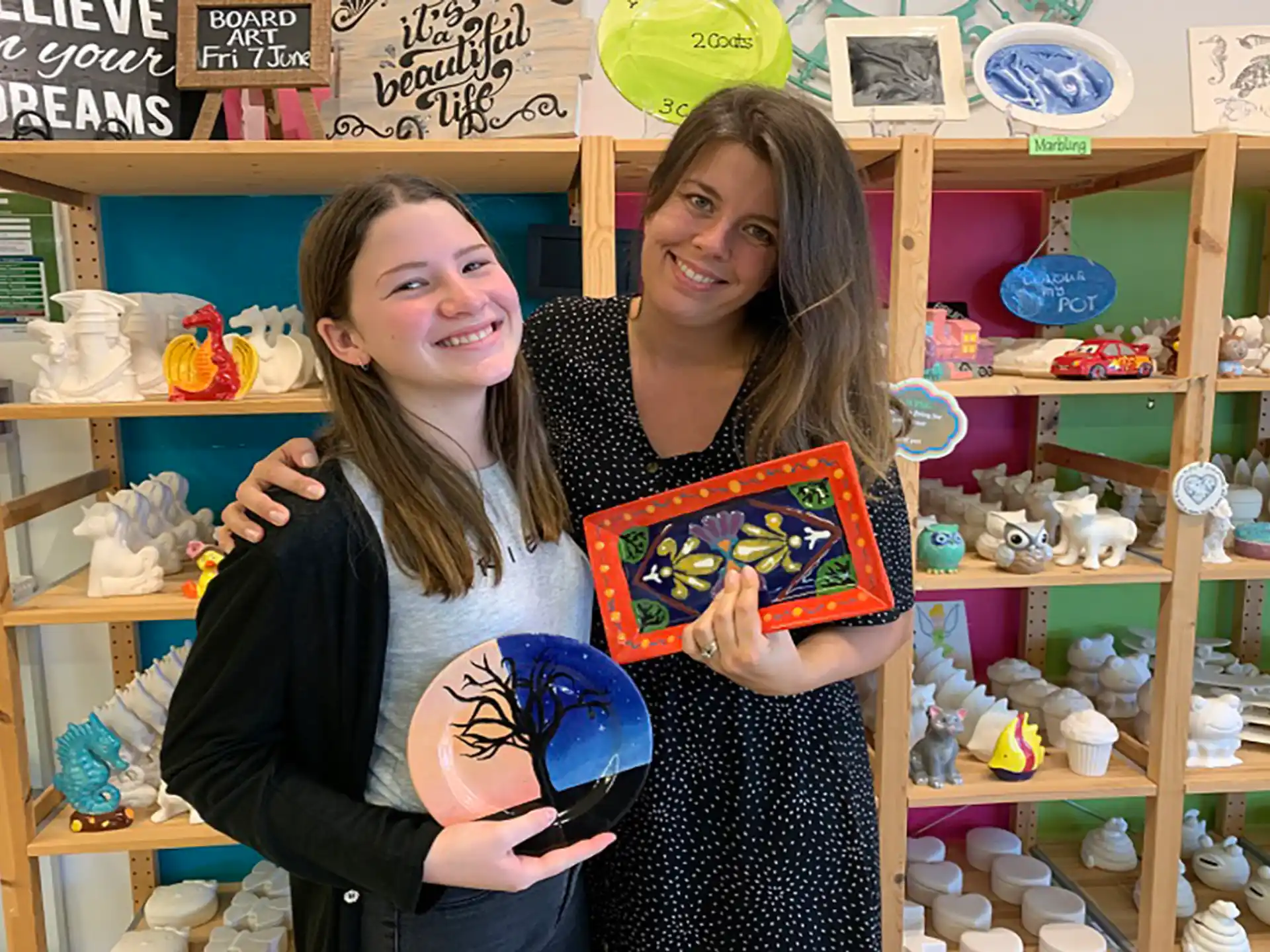 two girls holding a book