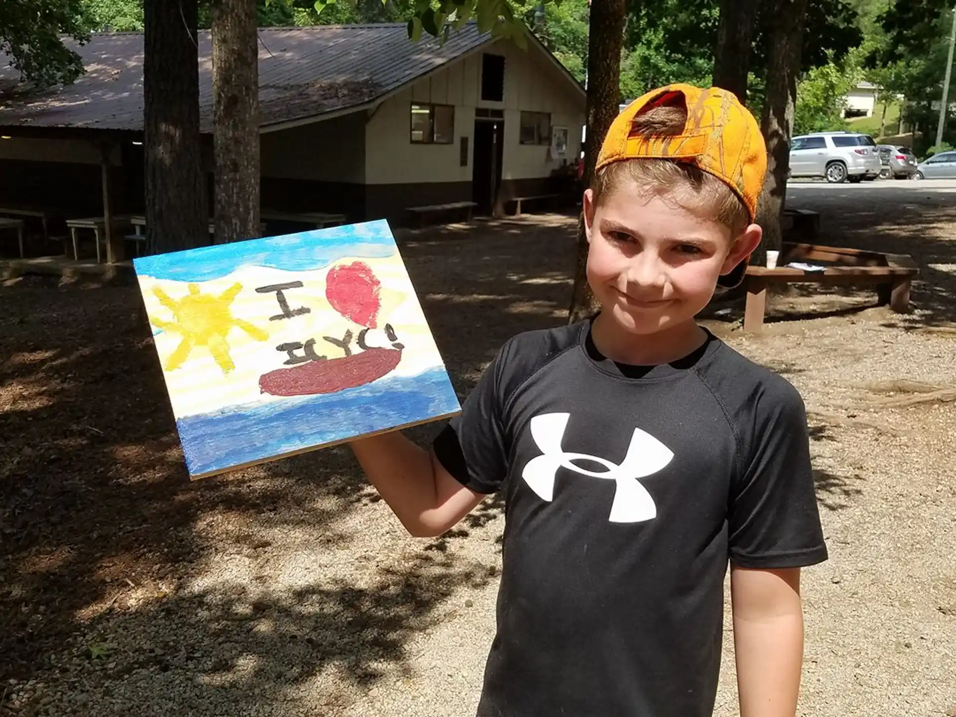 a boy holding a painting