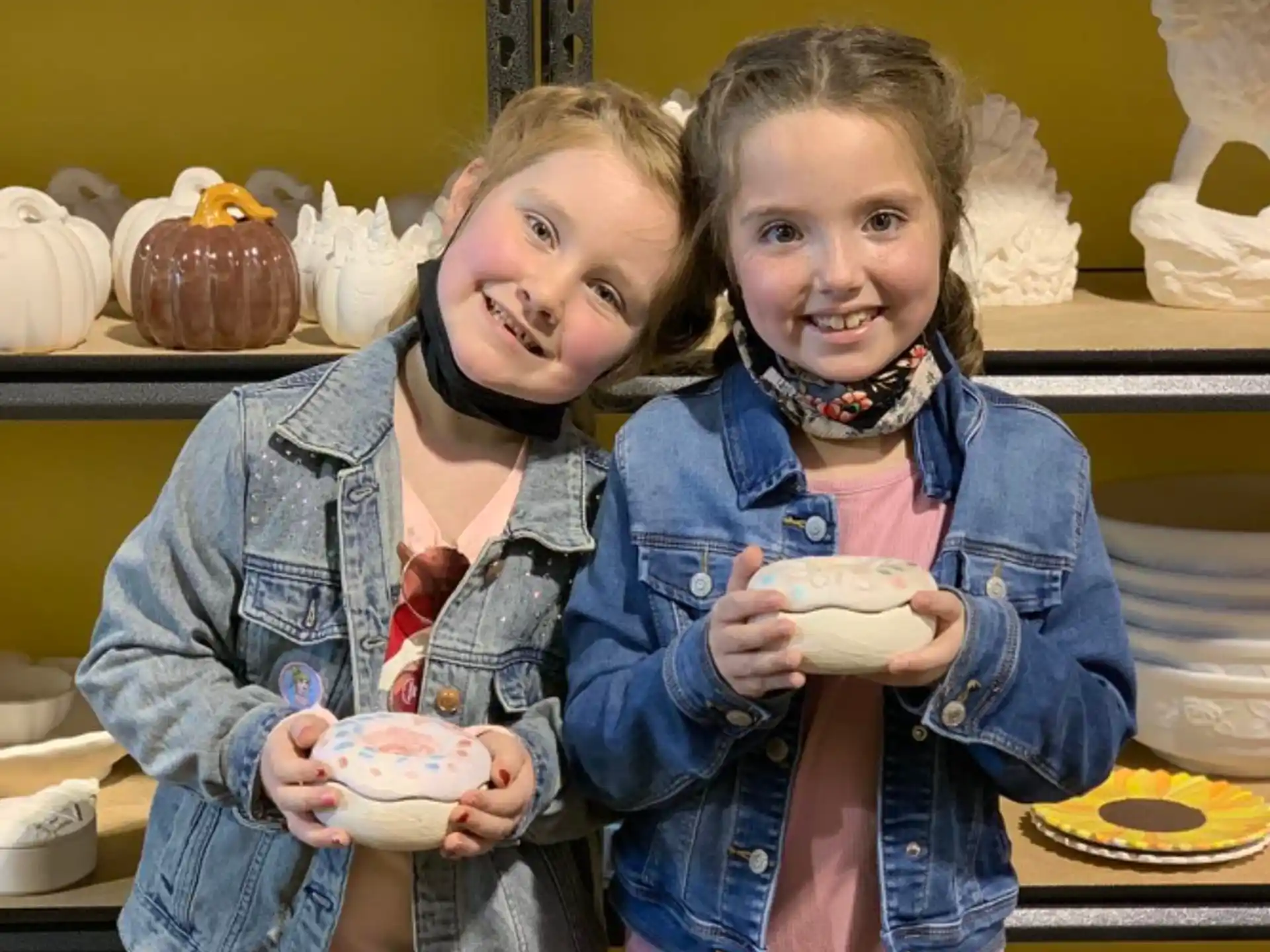 a couple of girls holding eggs