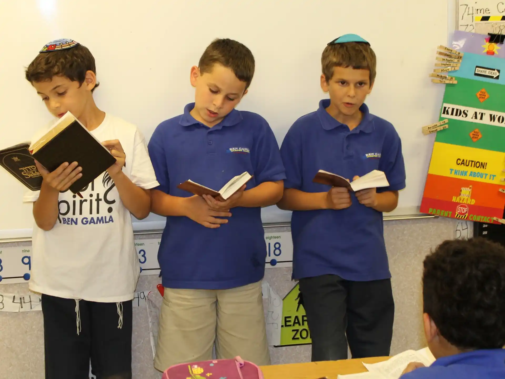 a group of kids holding books
