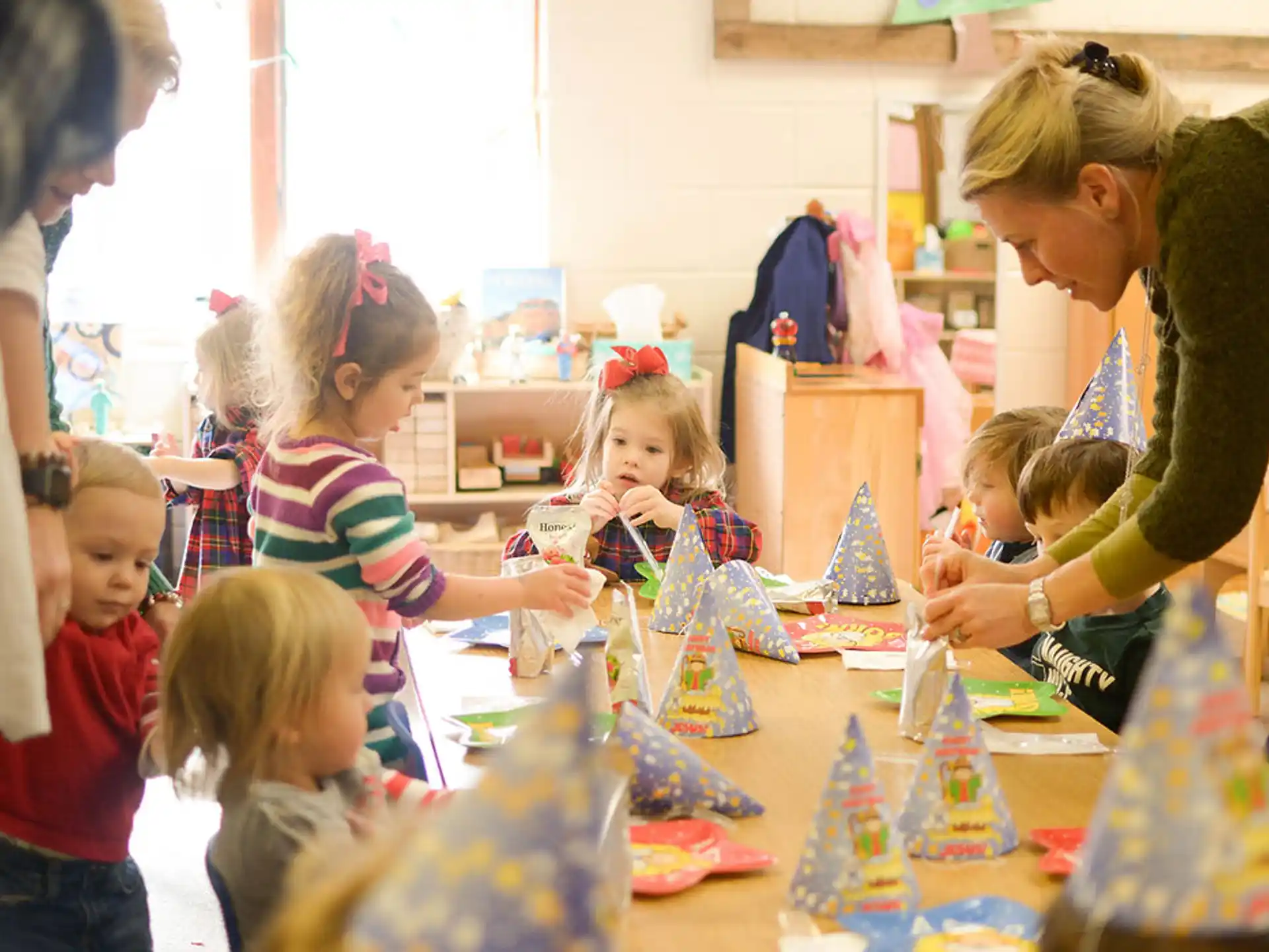 a person and children at a table