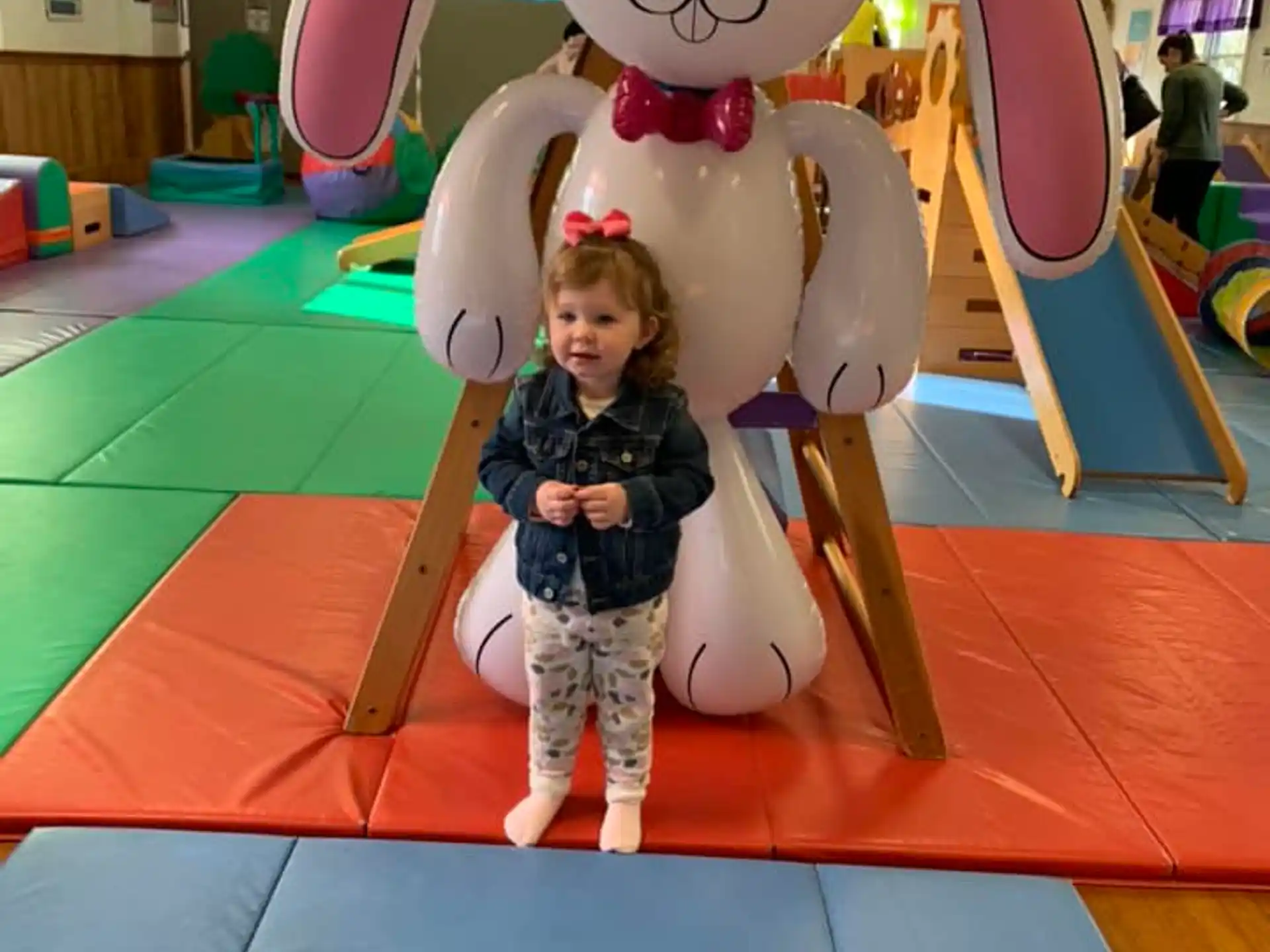 a child standing next to a large balloon