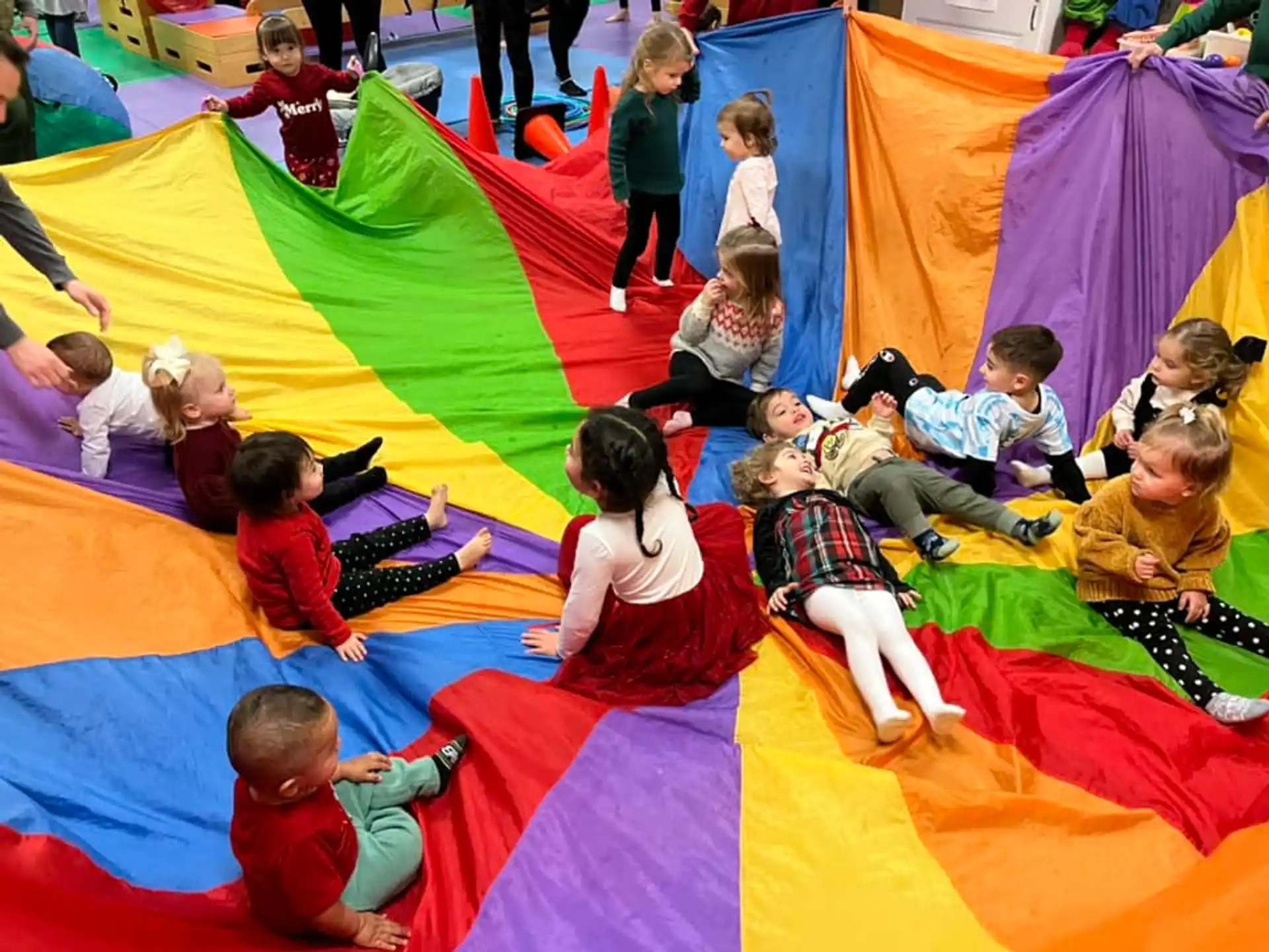 a group of children sitting on colorful mats
