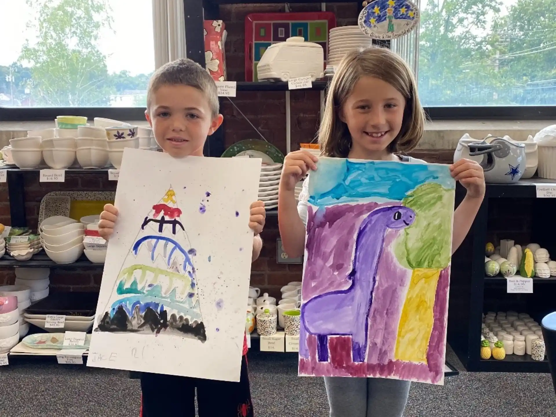 a couple of children holding up a sign