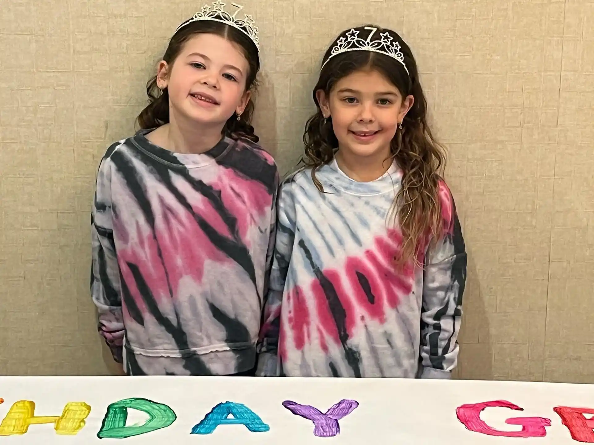 two girls wearing matching outfits