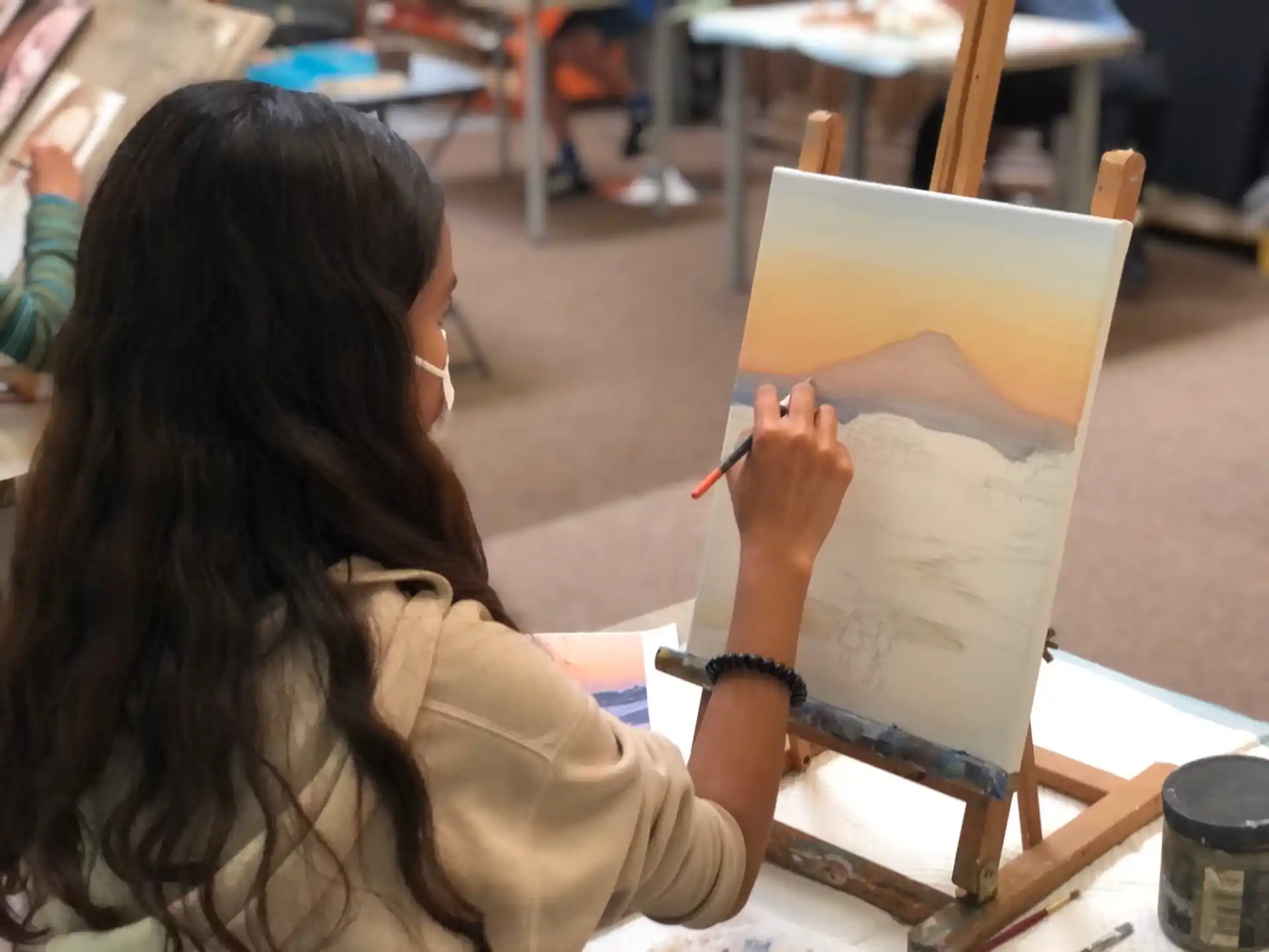 a woman drawing on a piece of paper