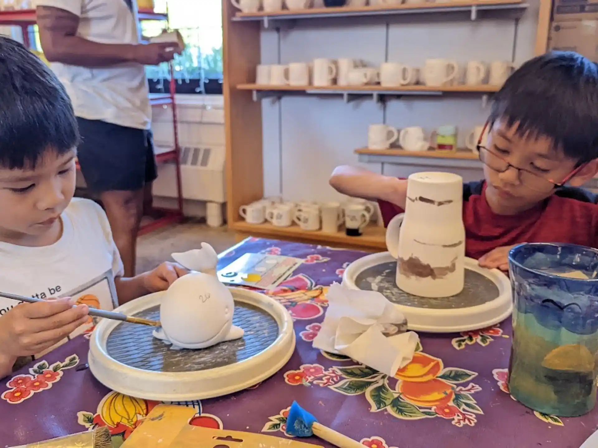 a couple of boys eating at a table