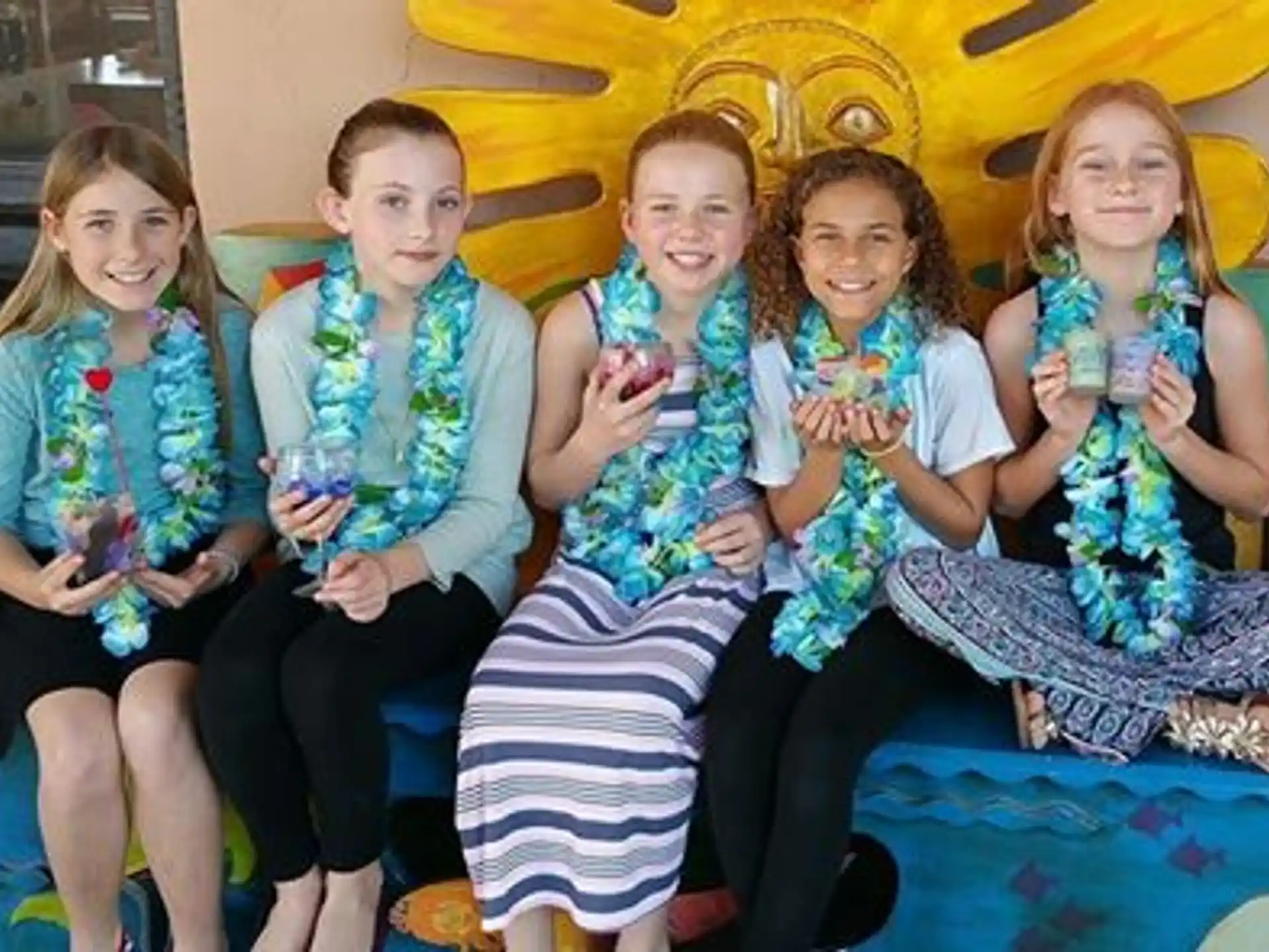 a group of girls sitting on a couch
