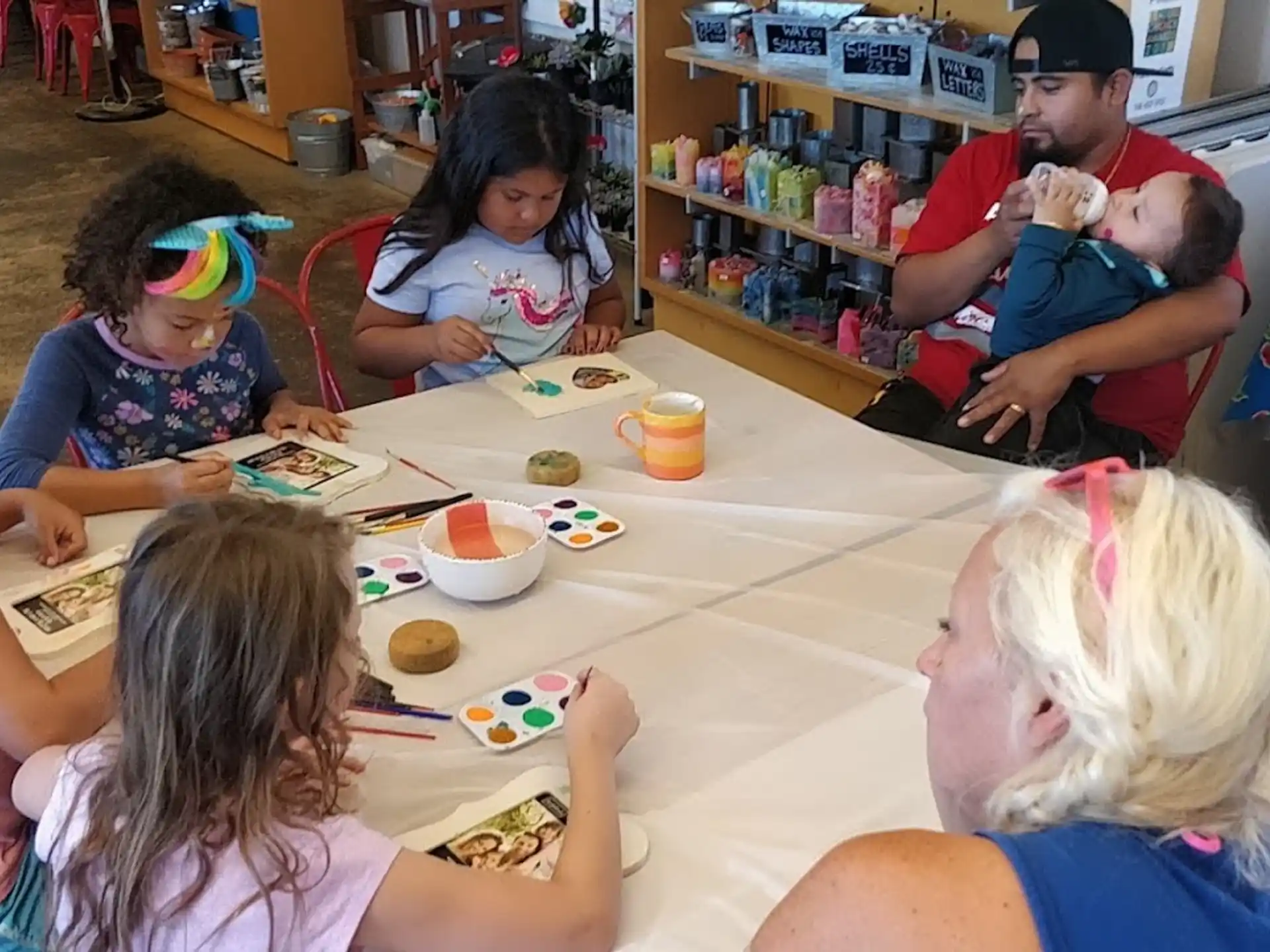 a group of people sitting around a table eating food