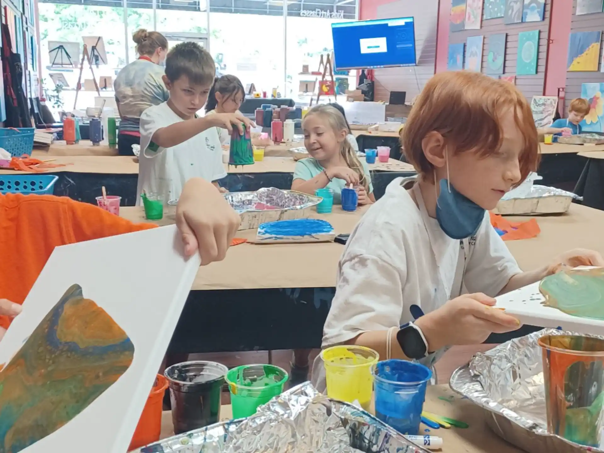 a group of children sitting at a table