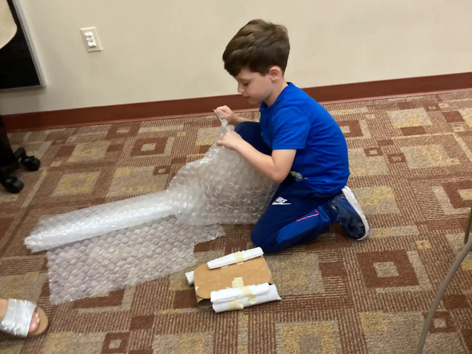 a boy sitting on the floor