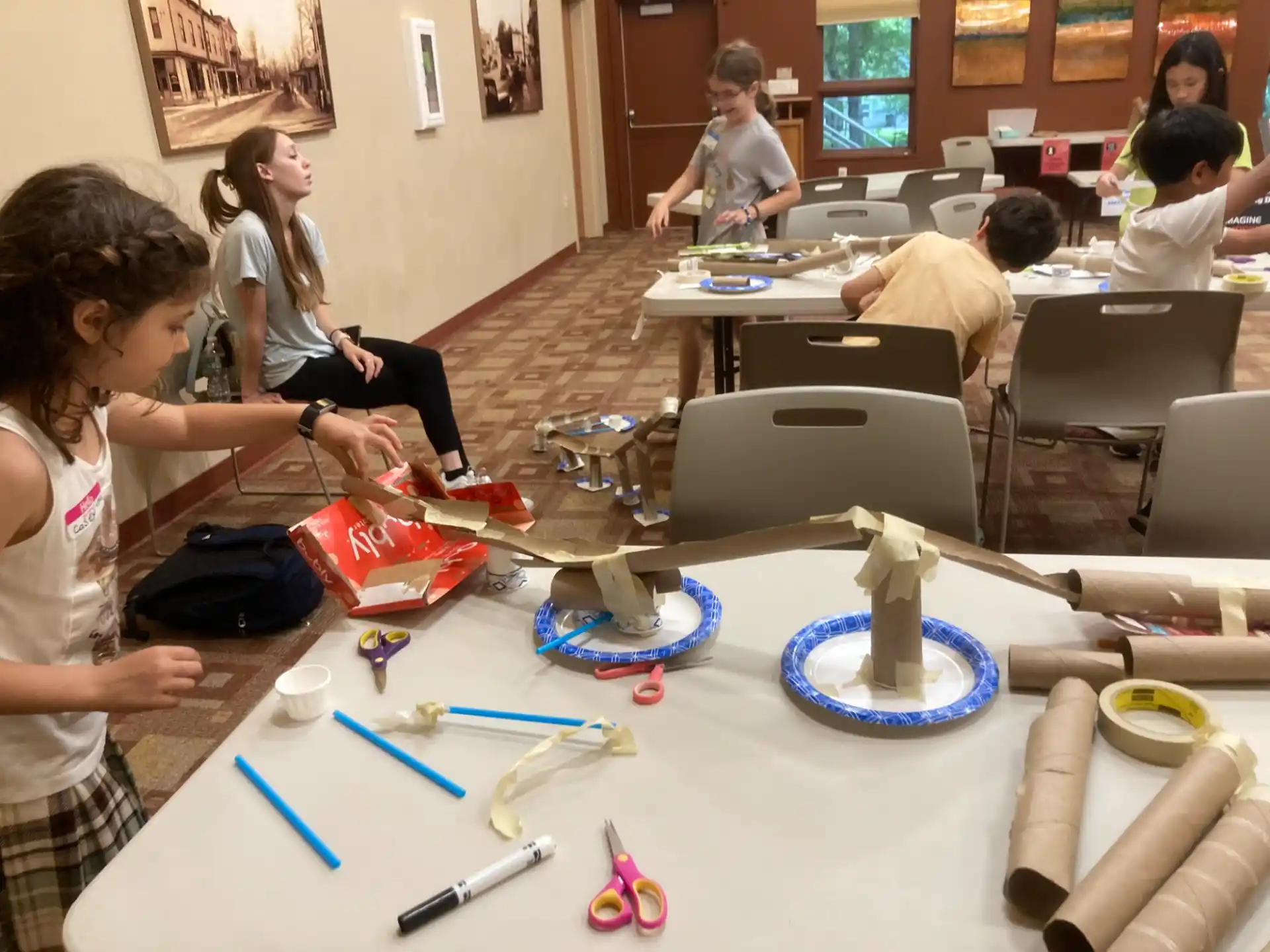 a group of people sitting at a table with blue plates and blue bowls