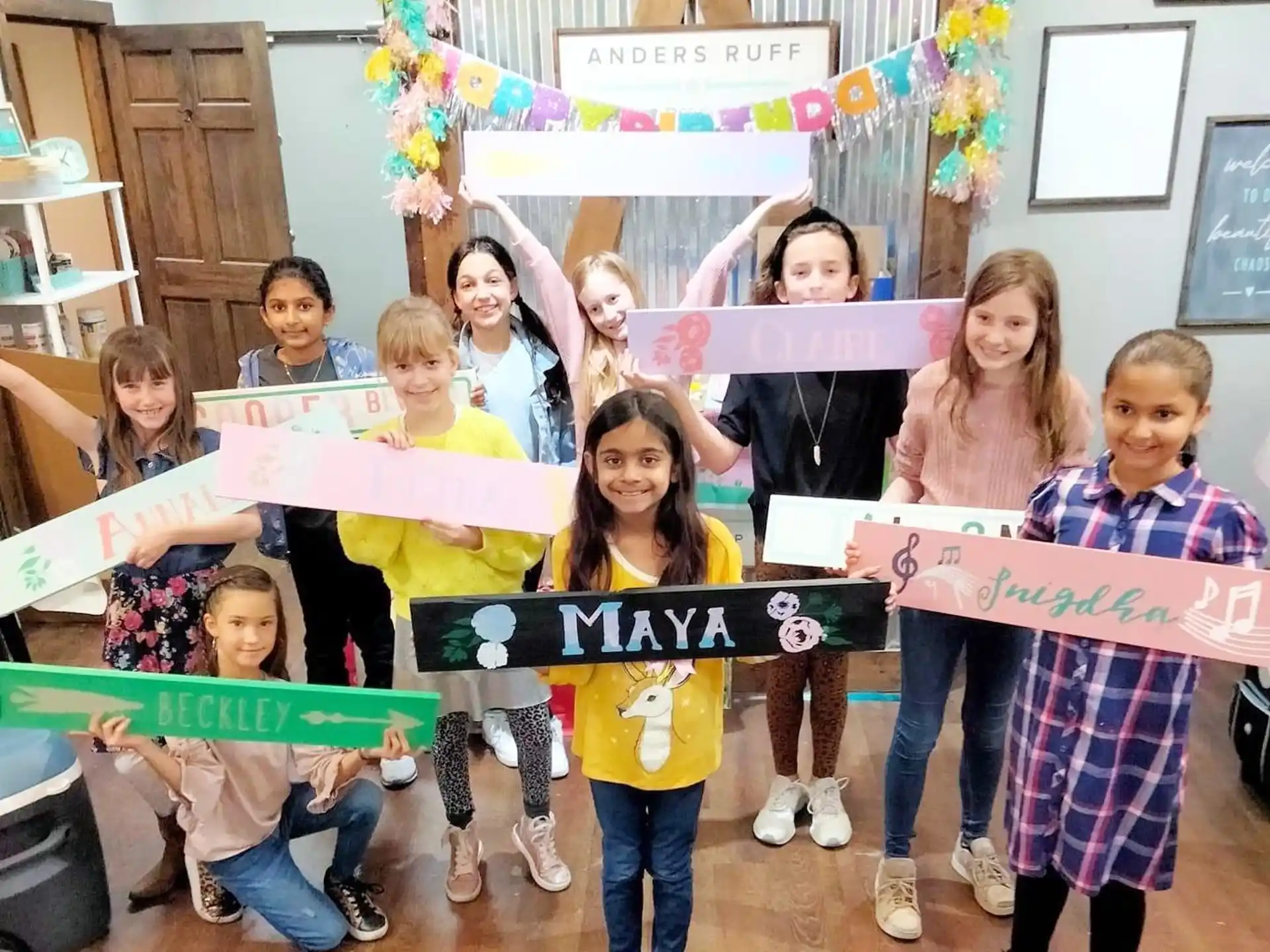 a group of children holding up a sign