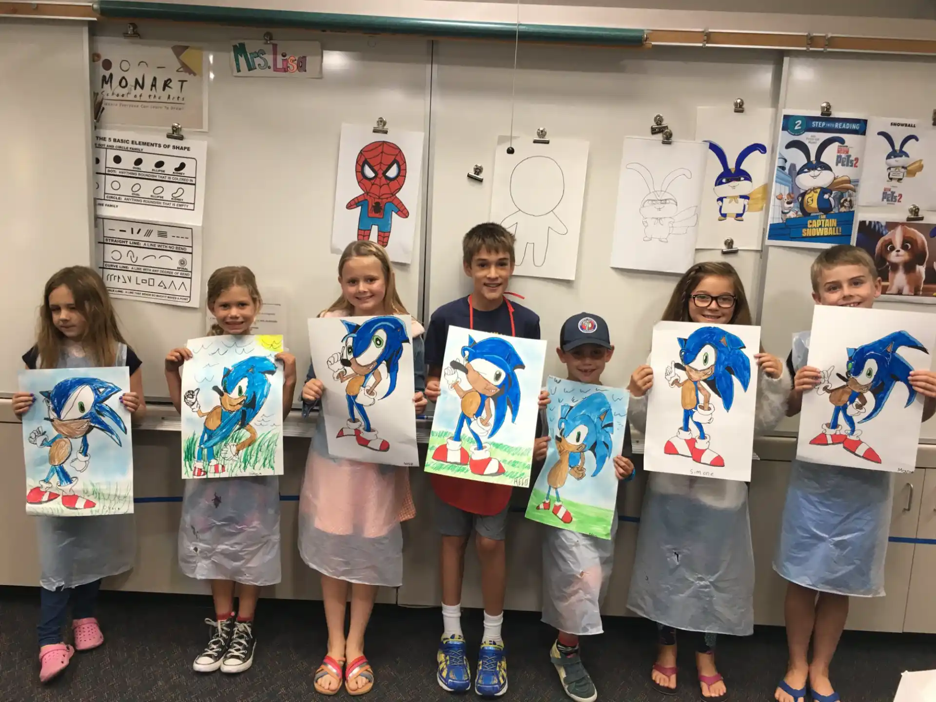 a group of children holding up posters