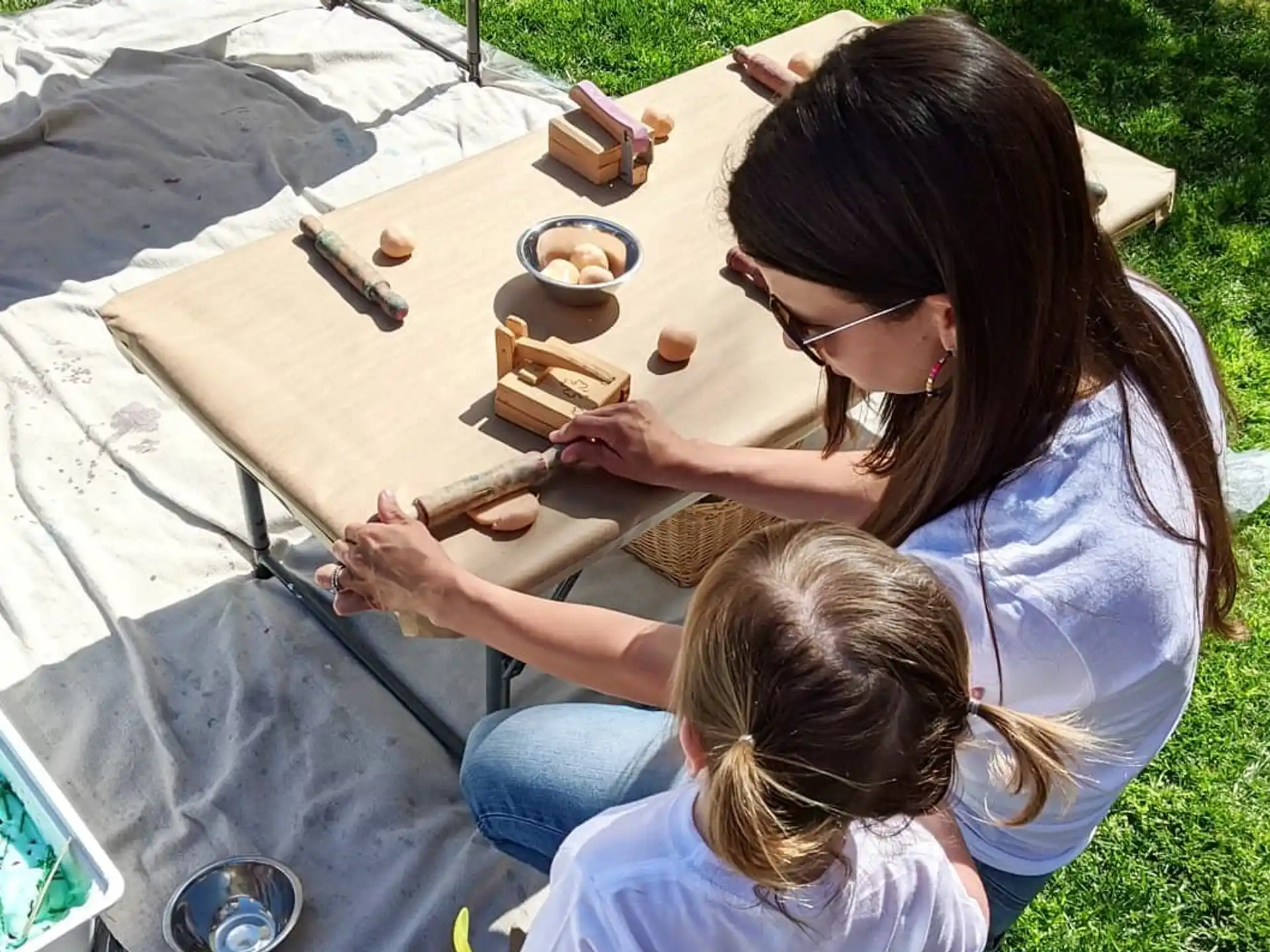 a woman and a child painting outside