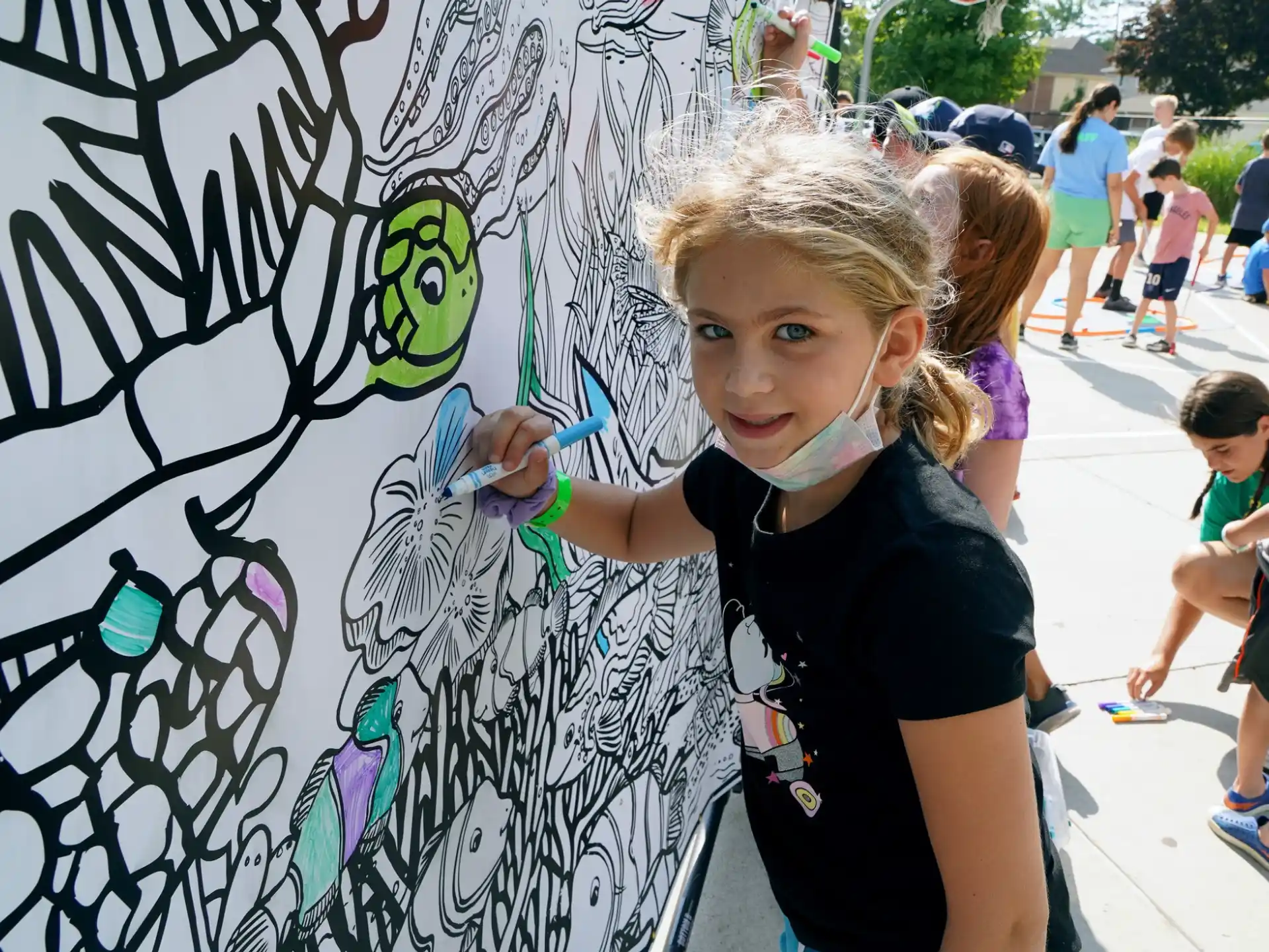 a girl painting a wall