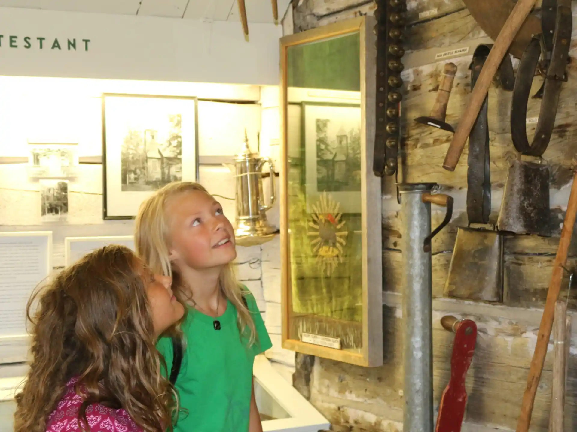 a woman and a girl looking at a painting