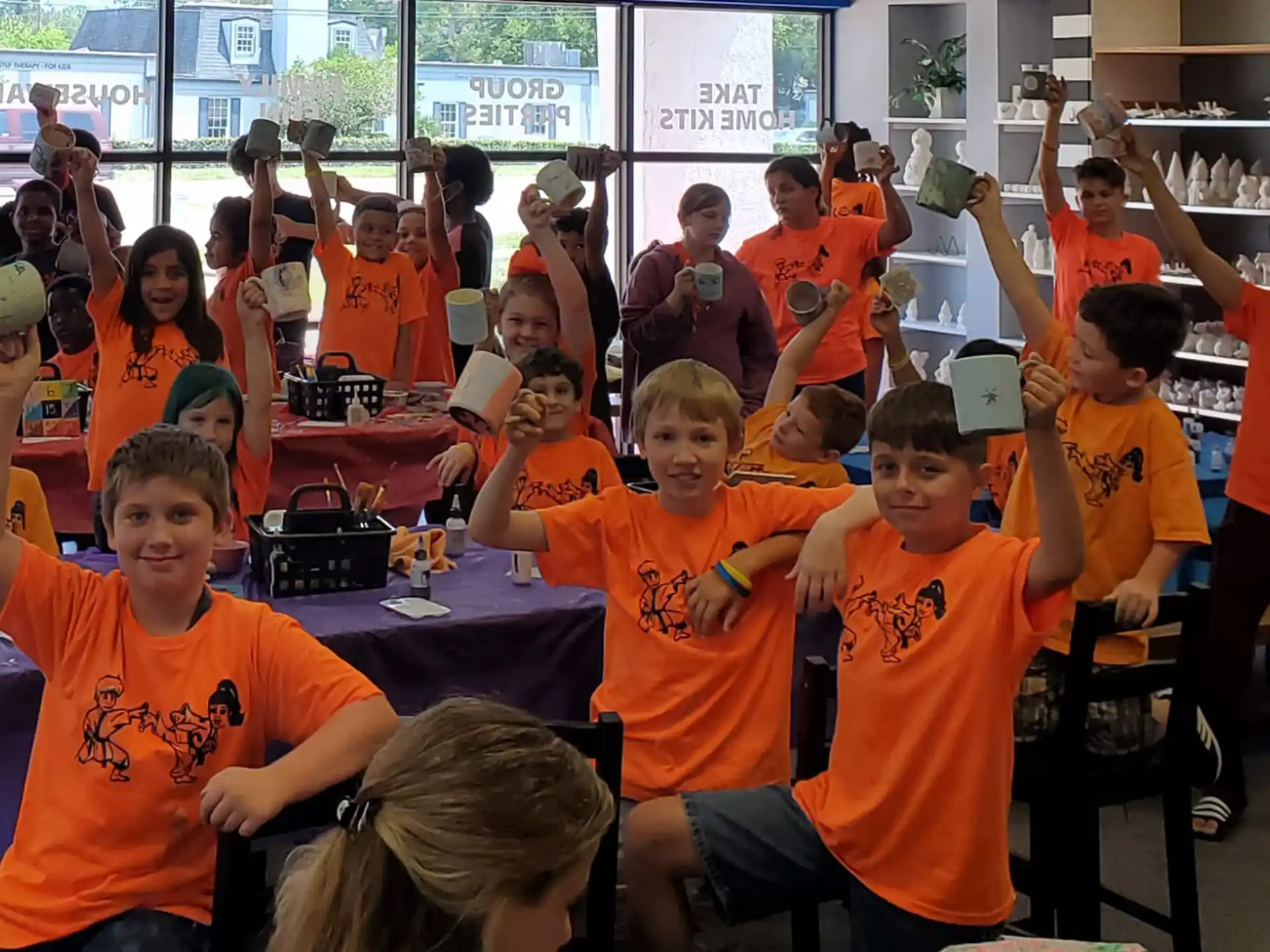a group of children in orange t-shirts