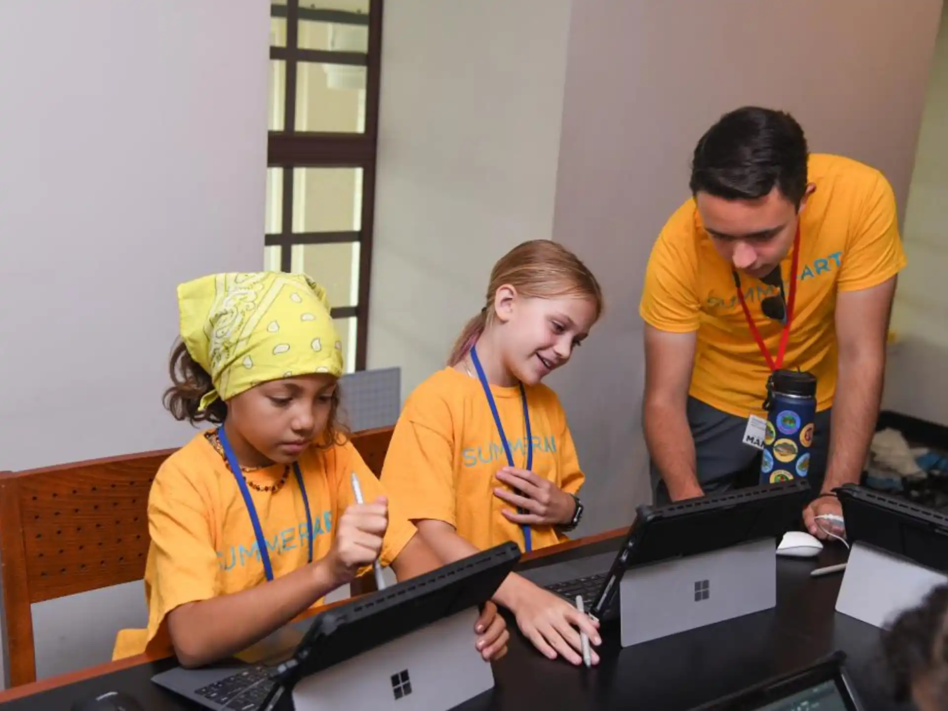 a group of people working on laptops