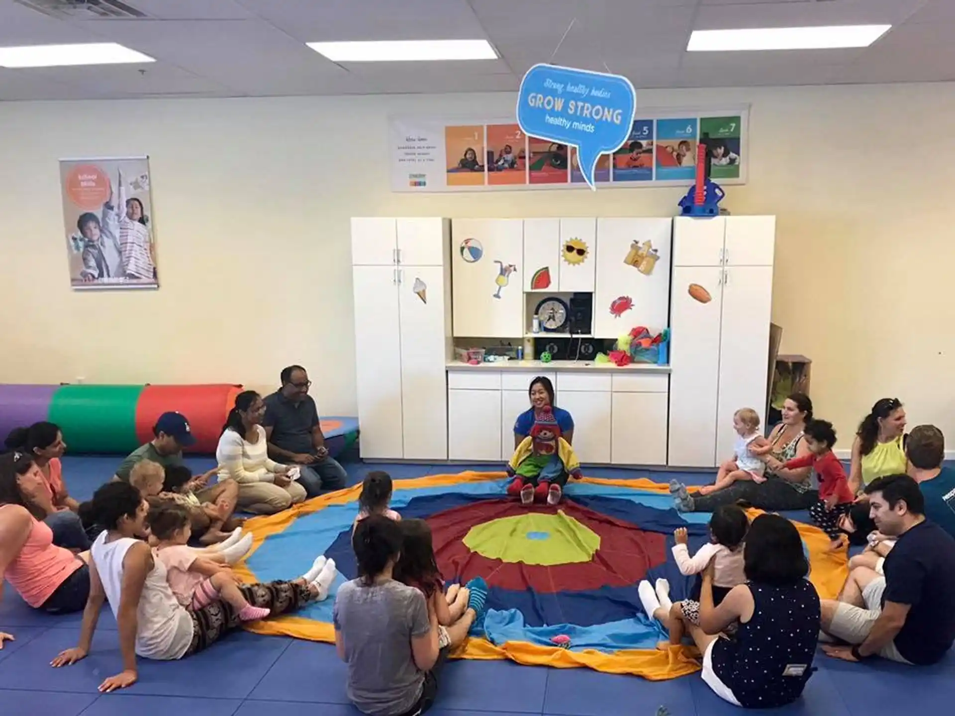 a group of people sitting on the floor in a room