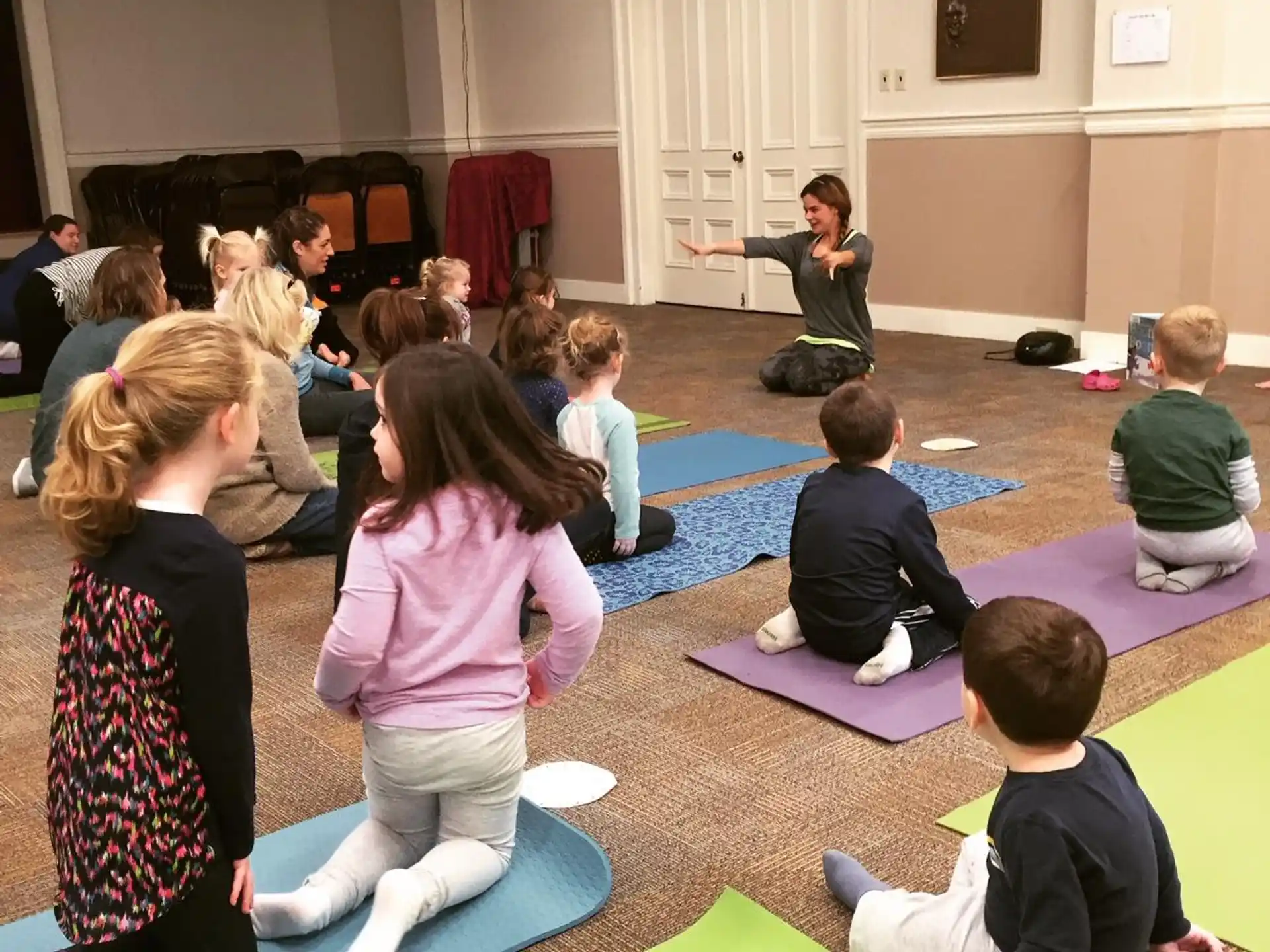 a group of children sitting on the floor in a room