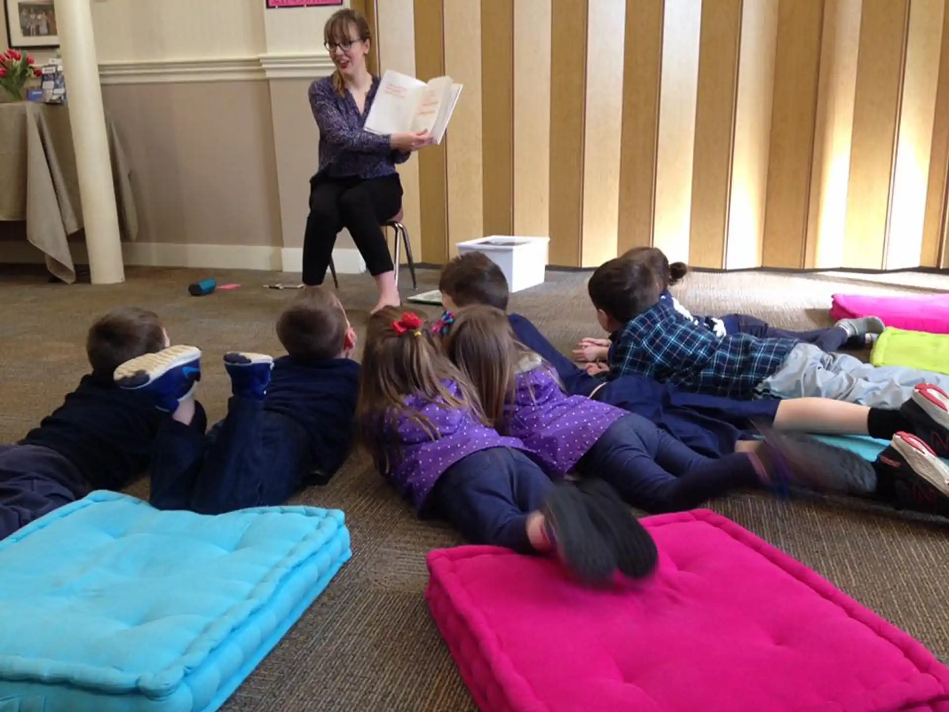 a group of people sitting on the floor reading books