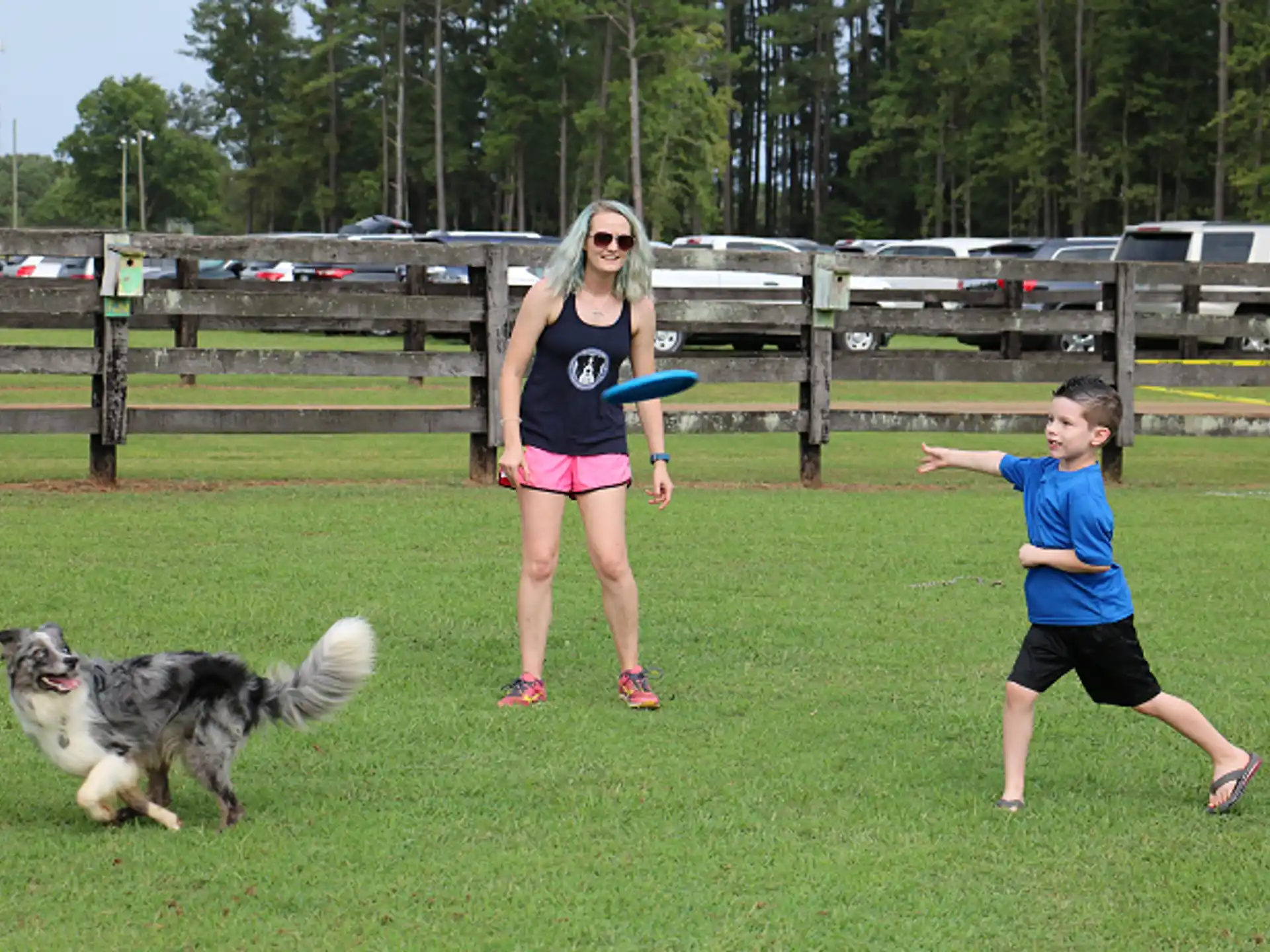 a person and a couple of kids playing frisbee