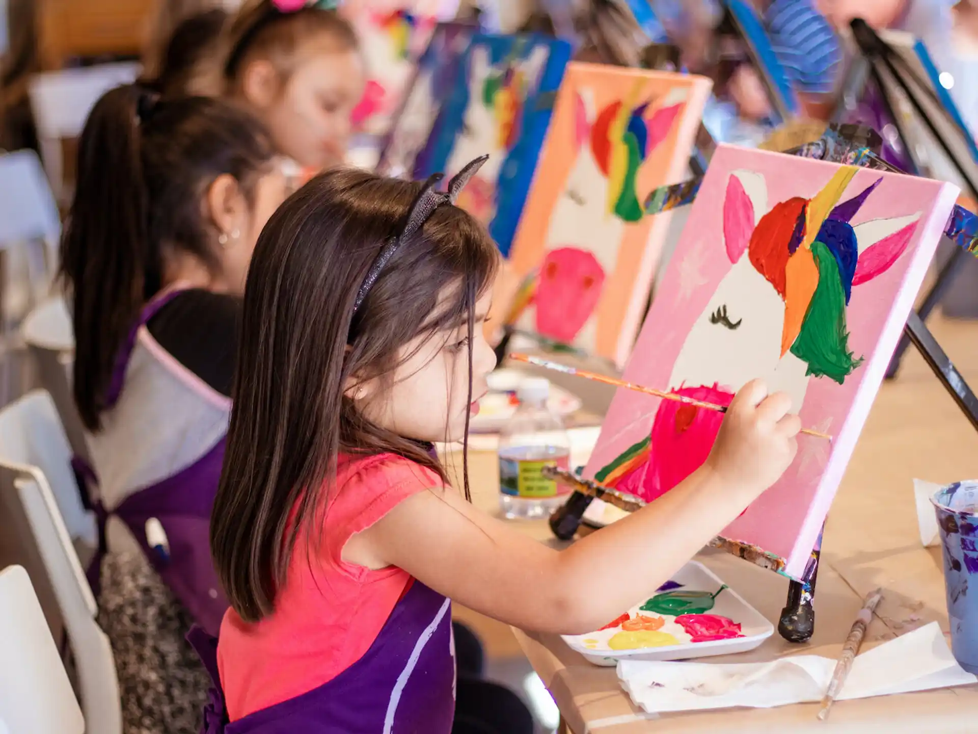 a group of children painting