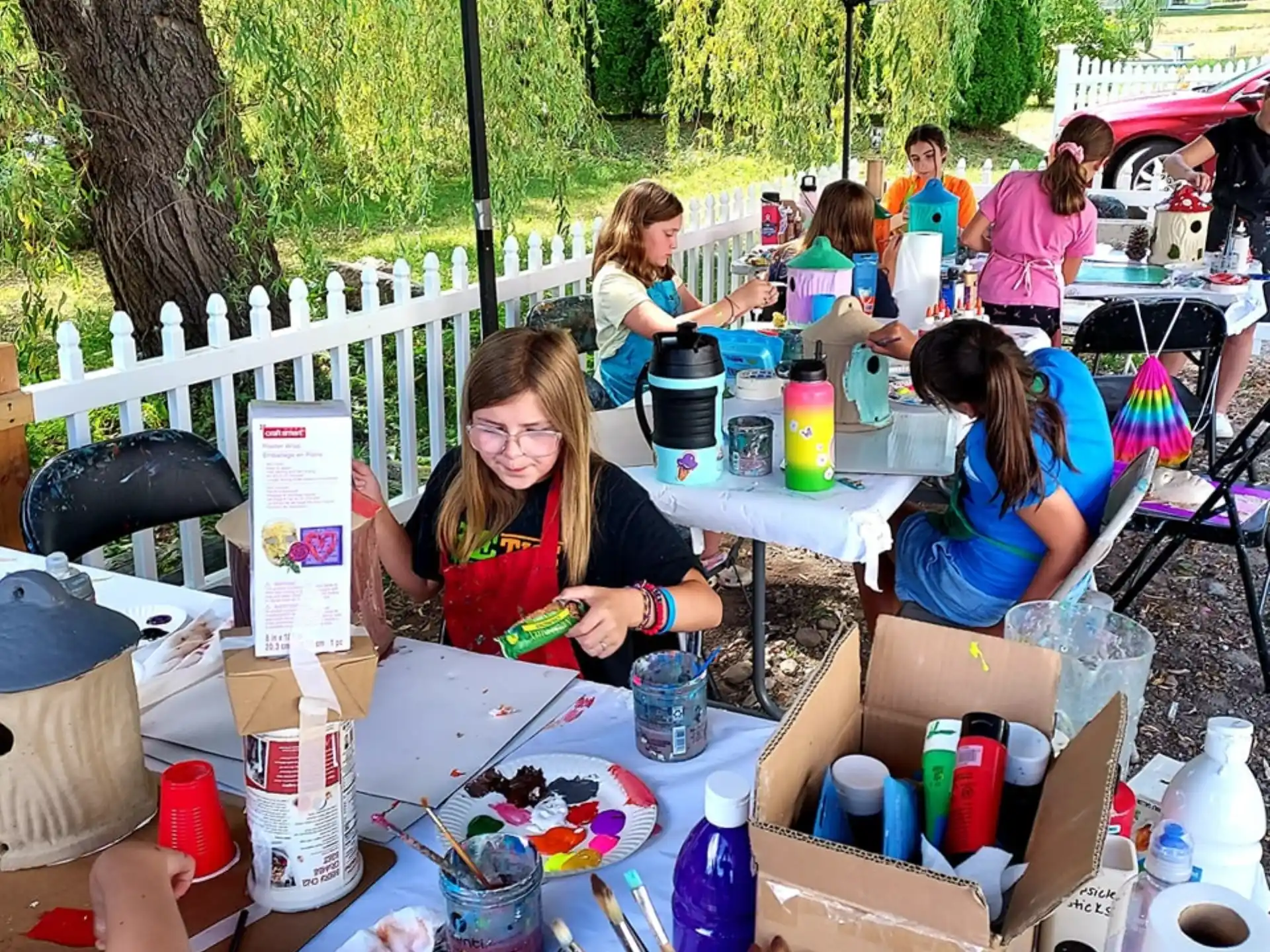 a group of people sitting at a table outside