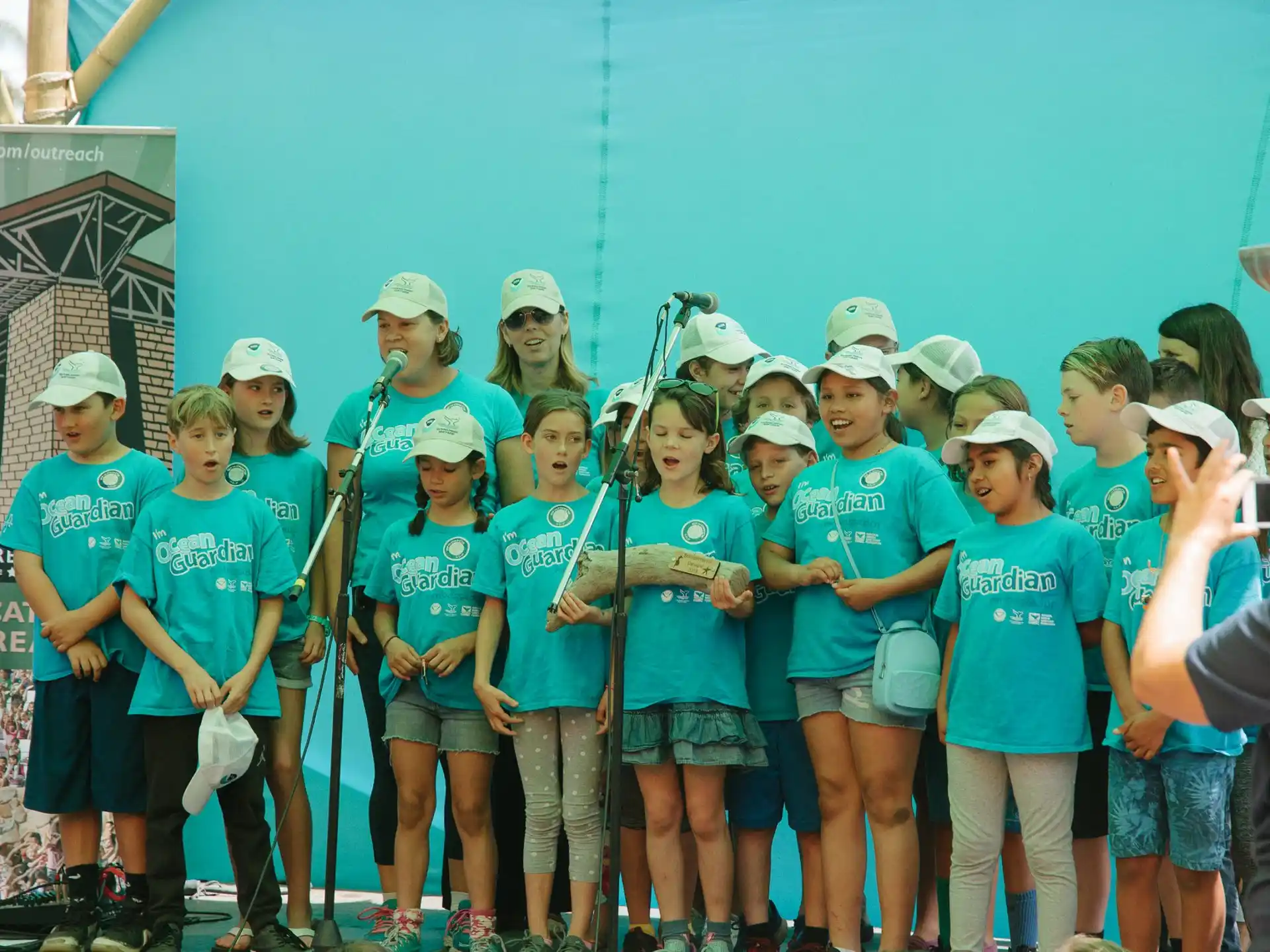 a group of people wearing matching t-shirts and hats