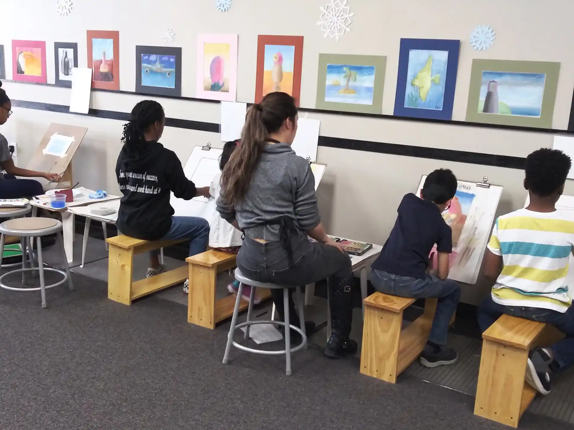 a group of people sitting at desks in a classroom