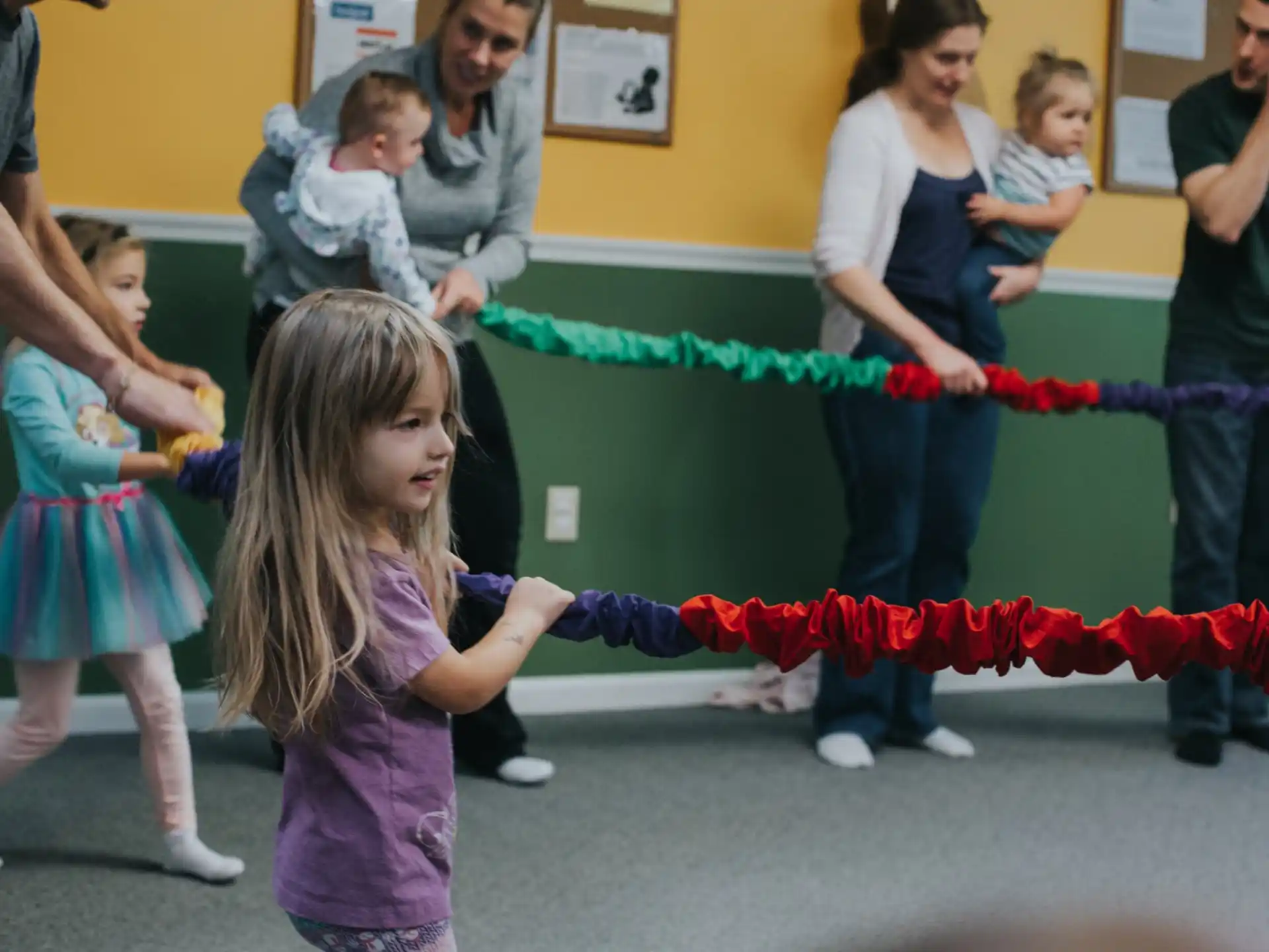 a group of children holding a ribbon