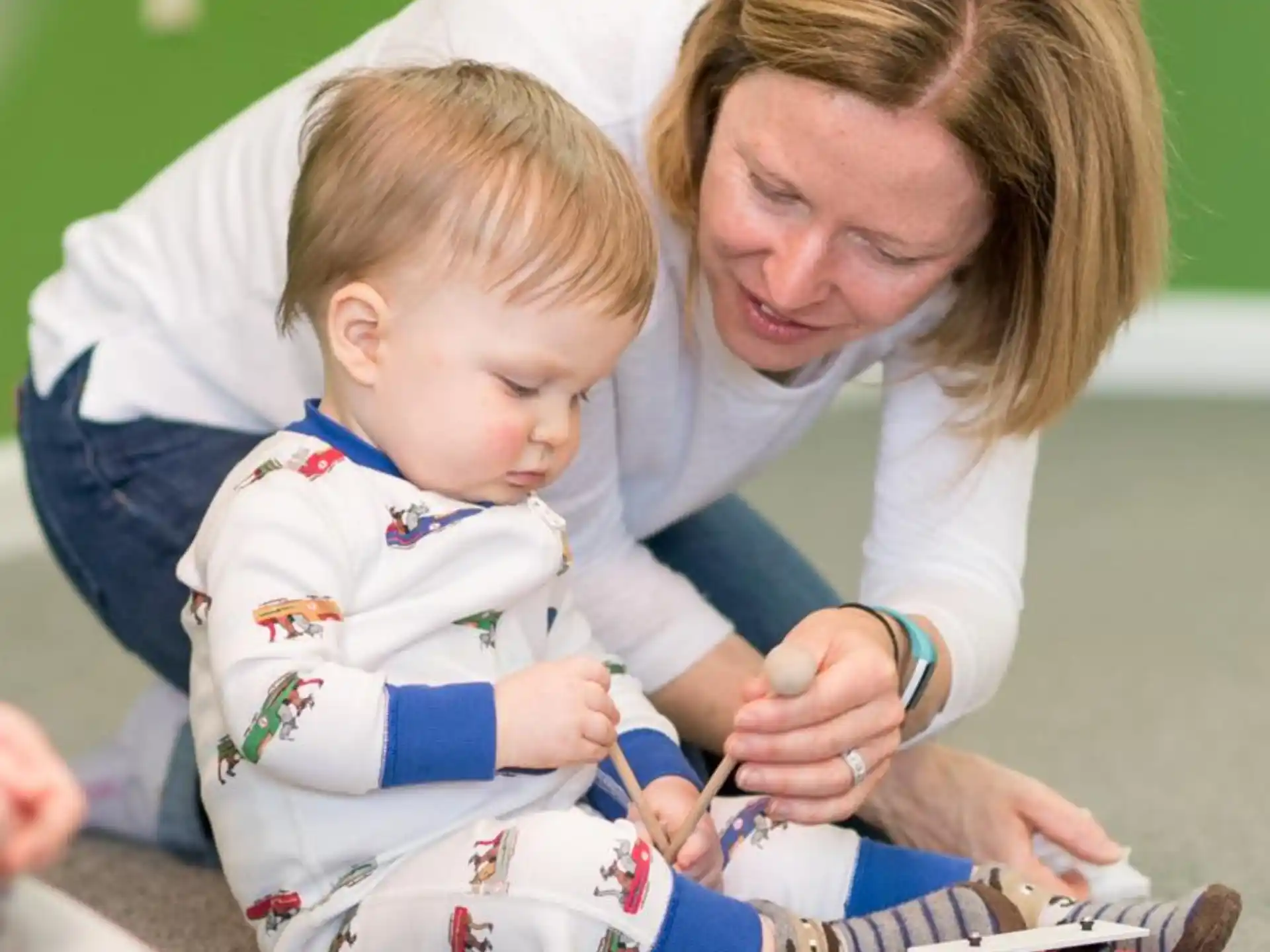 a woman and a baby playing with a toy