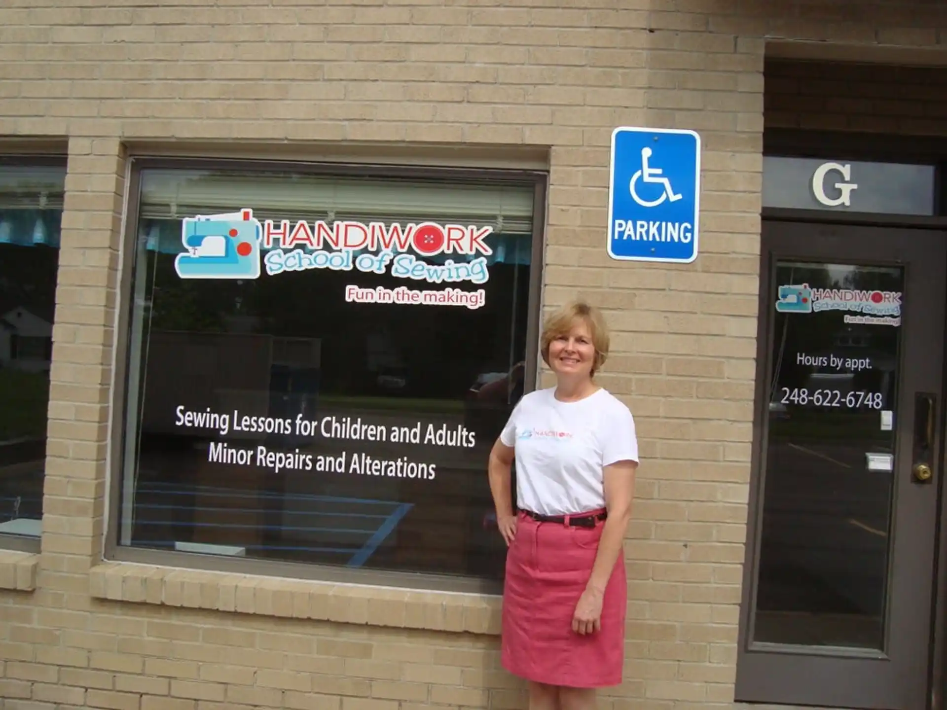 a person standing in front of a building with a sign on it