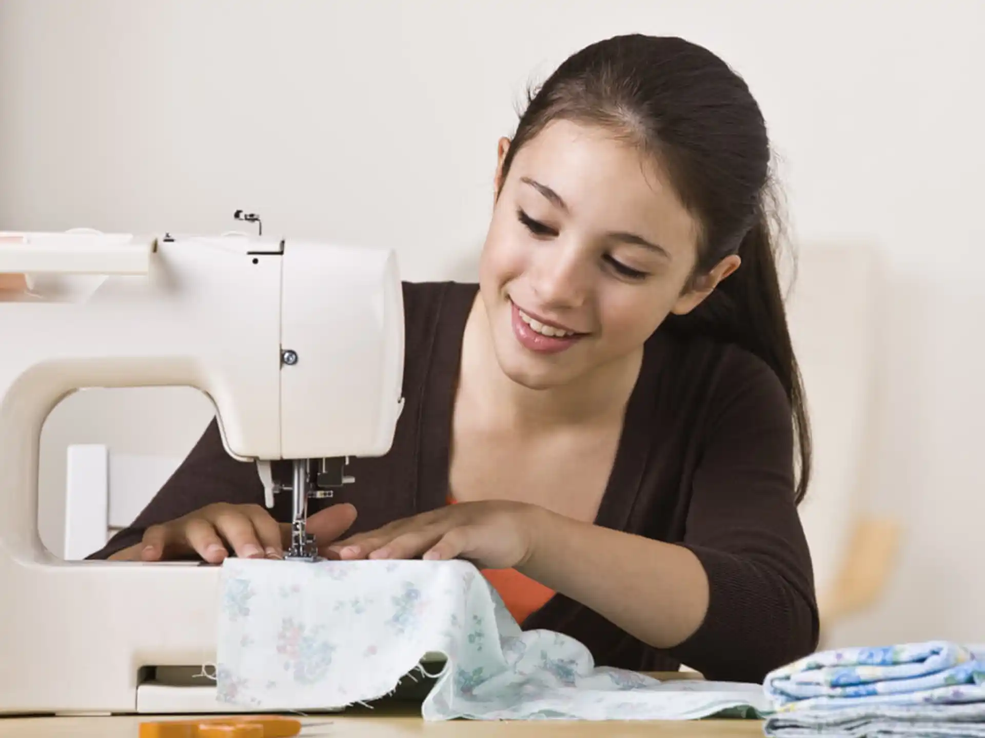 a woman sewing on a sewing machine